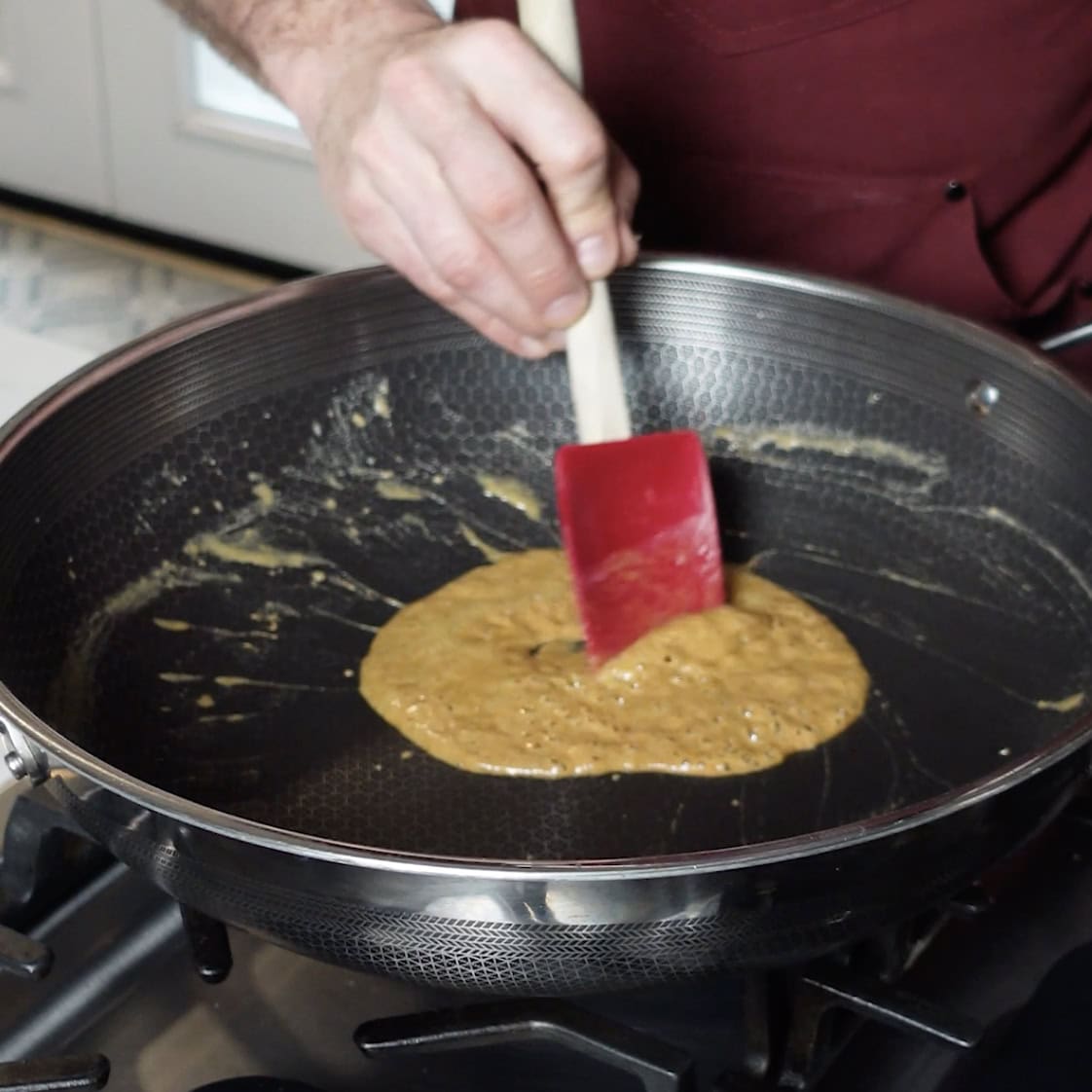 Stirring a roux in a skillet.