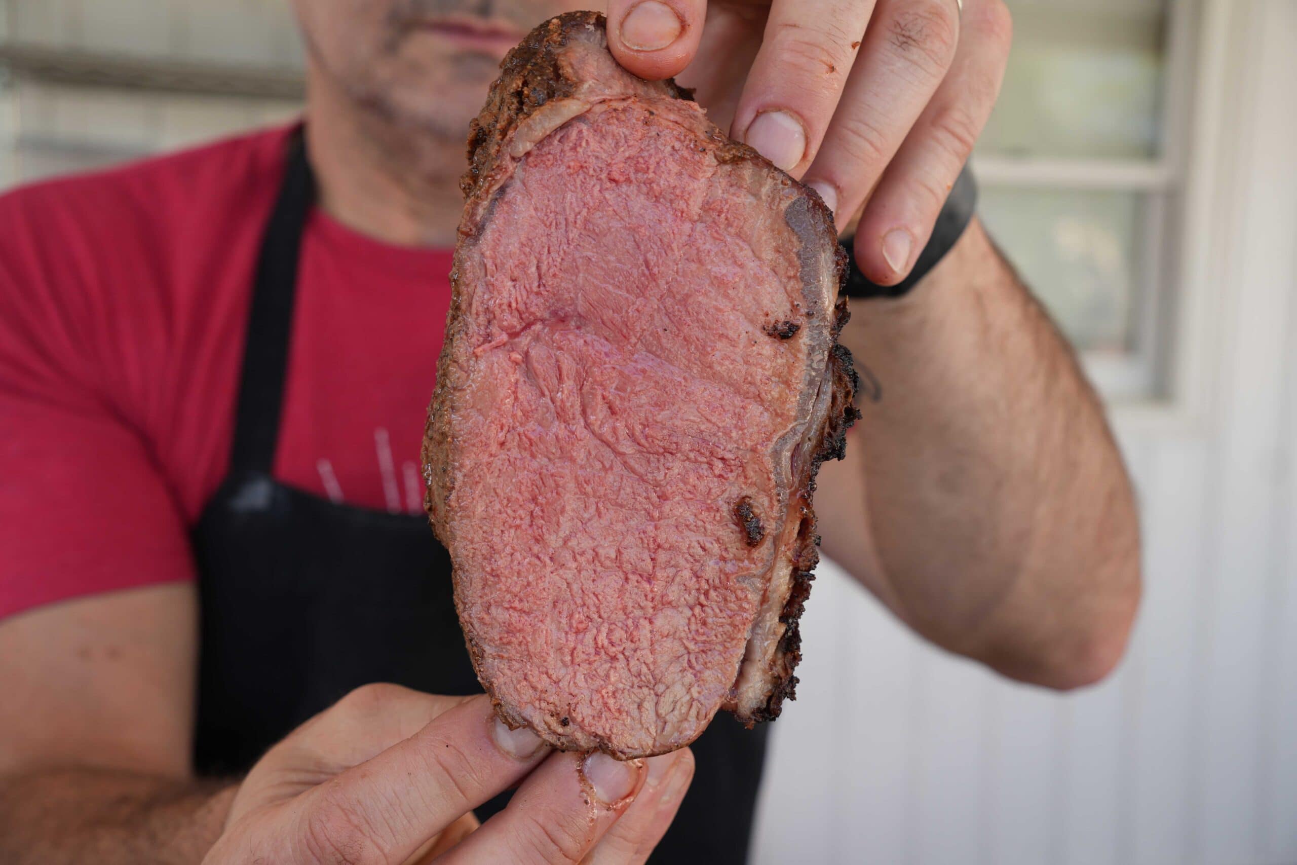 Slice of New York Strip Loin Roast cooked to medium rare.
