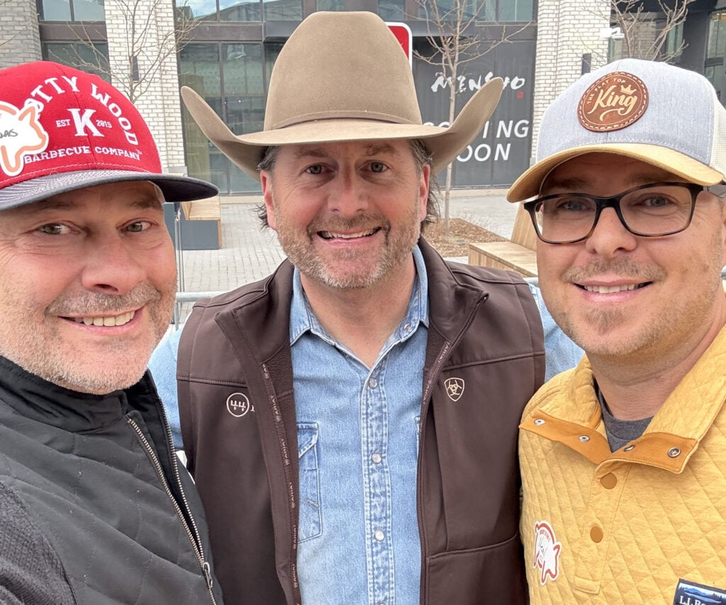 Tim and Neal with a man at the Traeger even in Salt Lake City.
