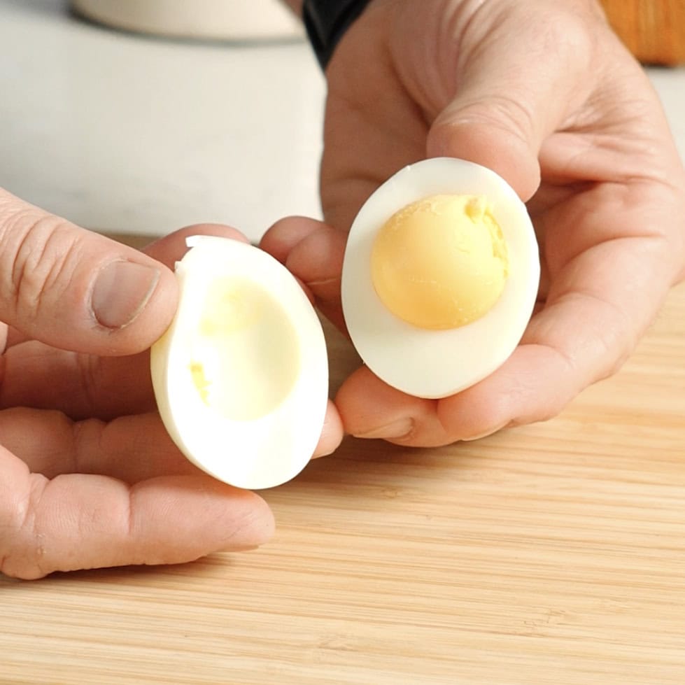 An egg cut in half to show egg yolk.