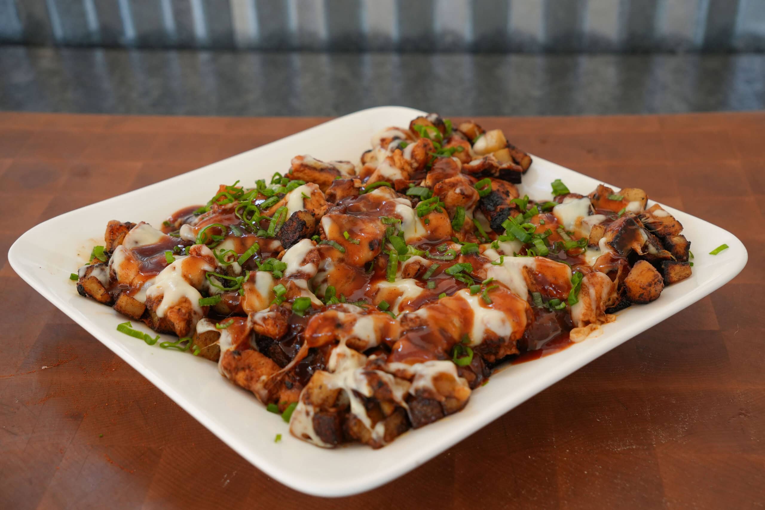 A spoonful of bbq chicken and potatoes from the griddle.