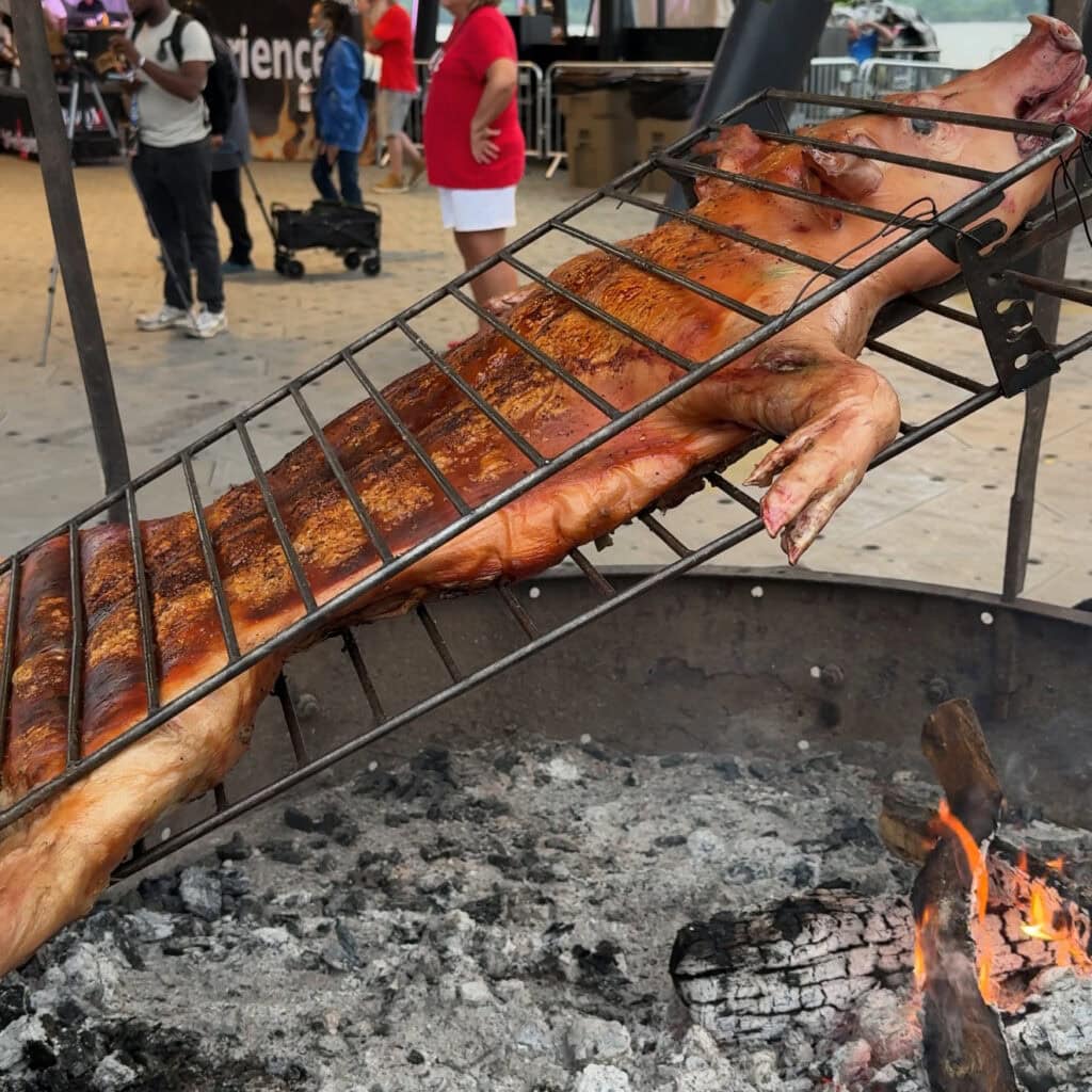 A whole pig cooking over flames