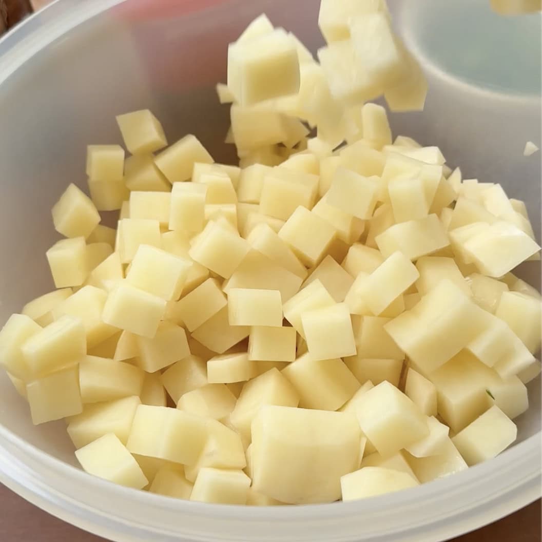 A bowl of cubed potatoes.