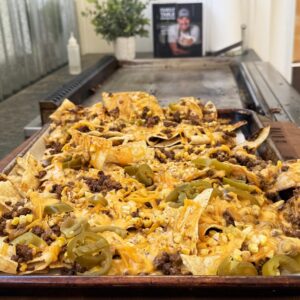Nachos topped with meat, cheese and jalapeños.