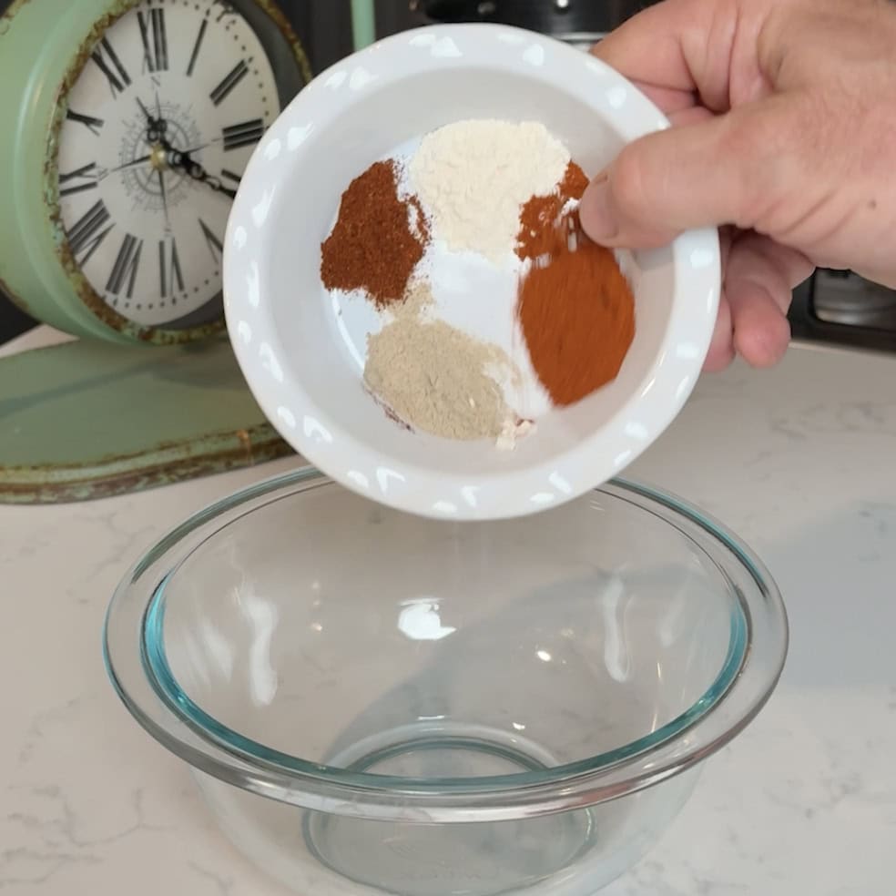 Mixing seasonings into a bowl for the boiled peanuts.