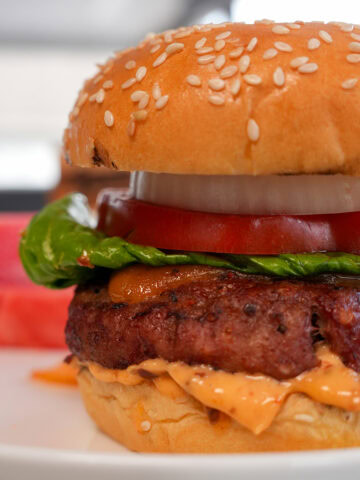 smoked hamburger with tomato and lettuce.