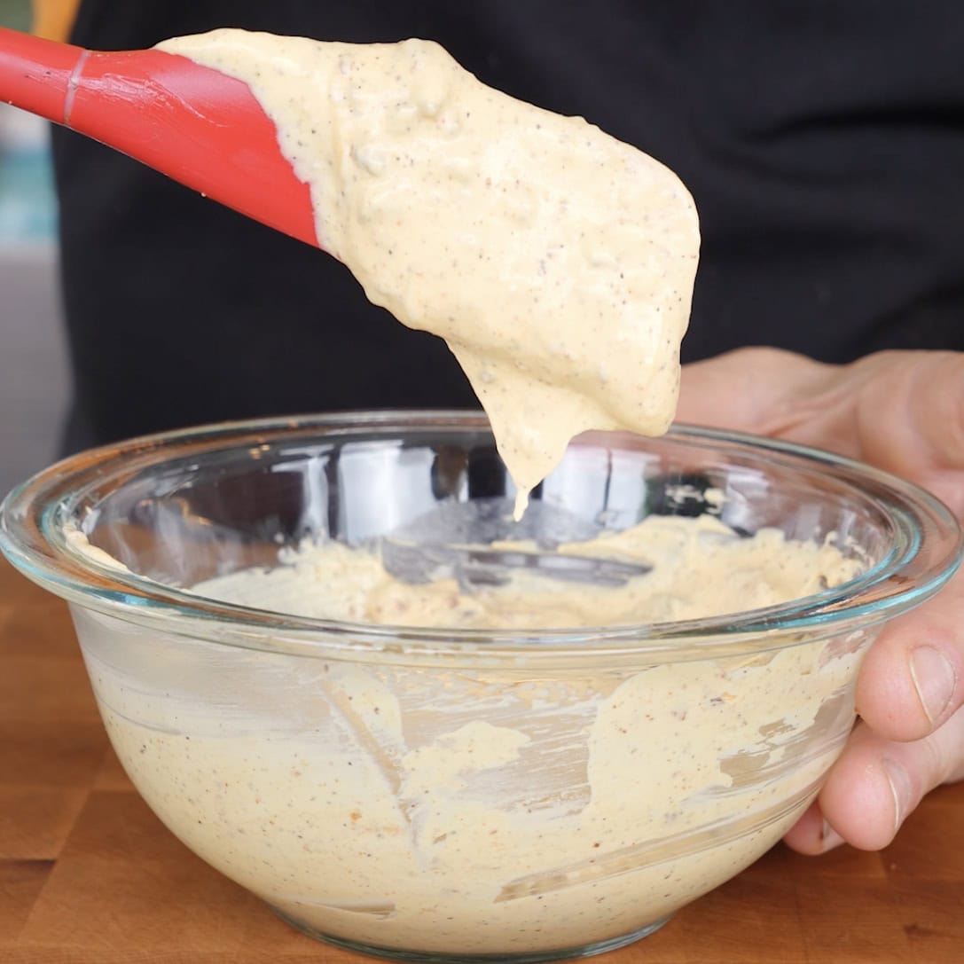 Sauce on a spatula from the glass mixing bowl.