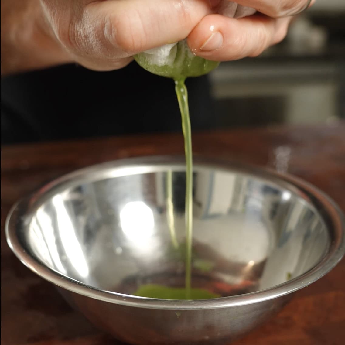 Straining off cucumber juice from slices cucumbers.