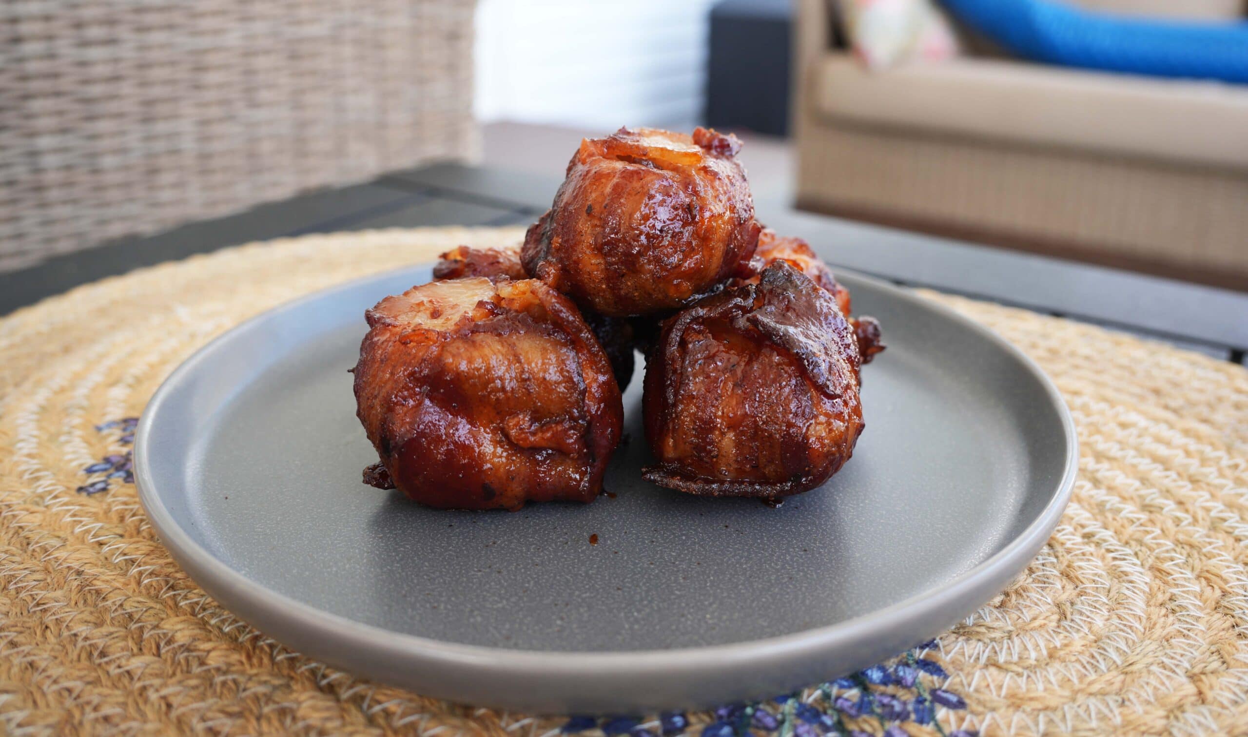 Finished chicken thighs on a grey plate.