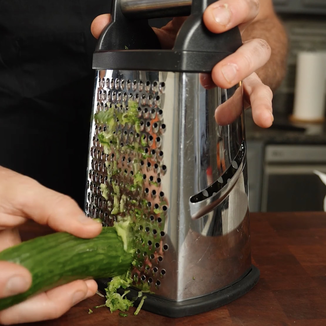 Grating a cucumber for dip.