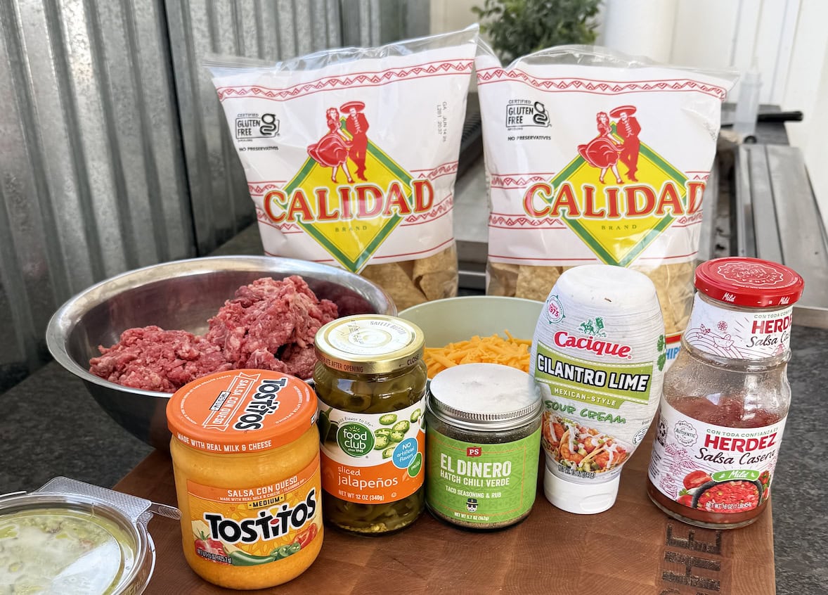 Ingredients for nachos laid out by the griddle.