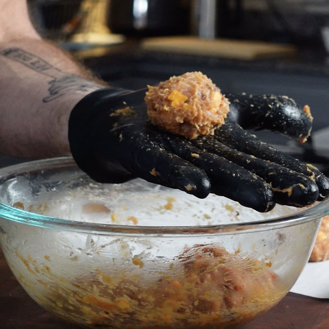 Making chicken thigh meat balls to wrap in bacon.
