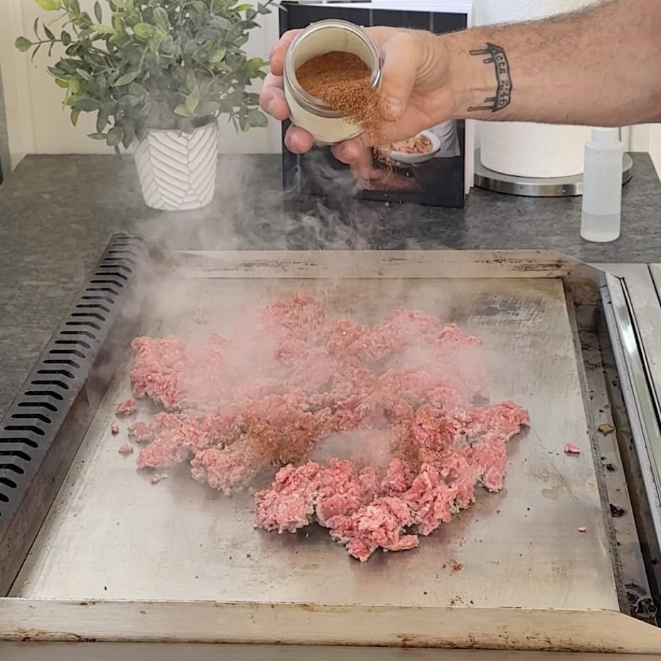 Seasoning taco meat on the griddle.