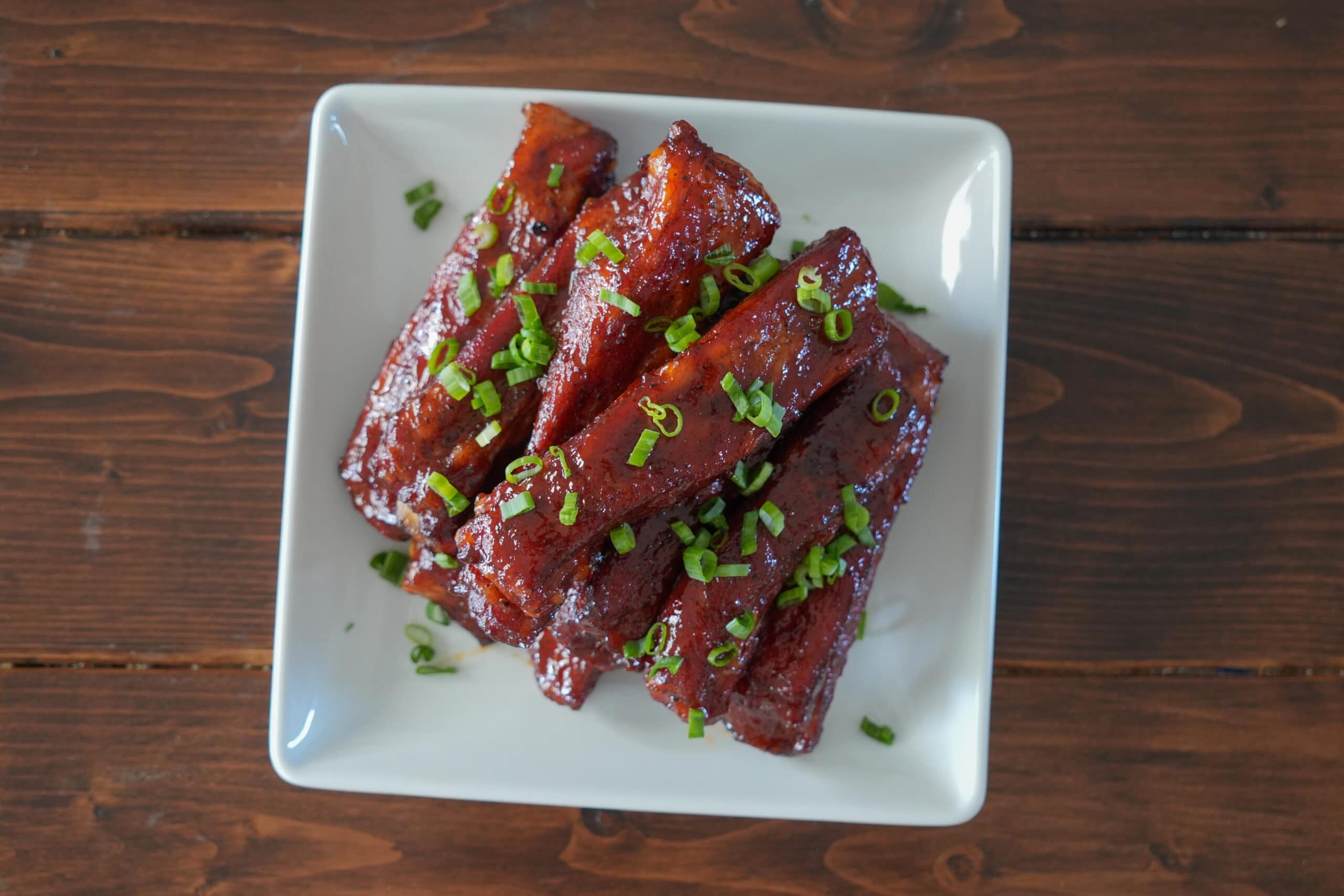 Ribs stacked up on a plate.