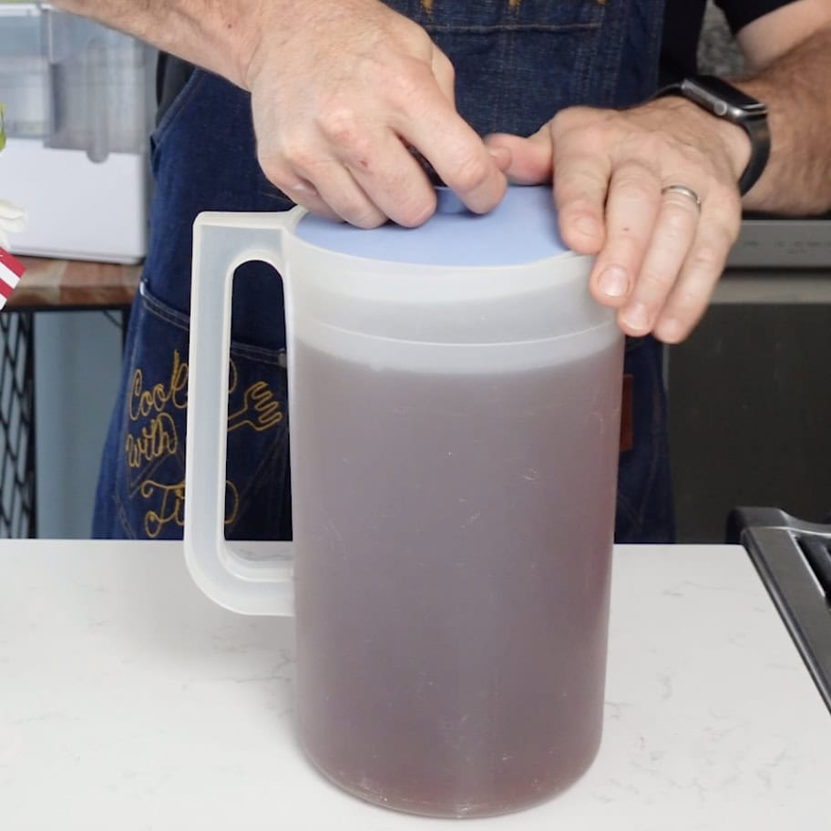 Placing the lid on the iced tea pitcher