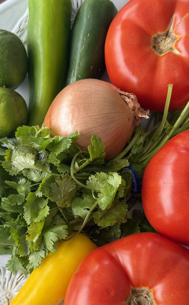 Cilantro, tomatoes and peppers on a plate.