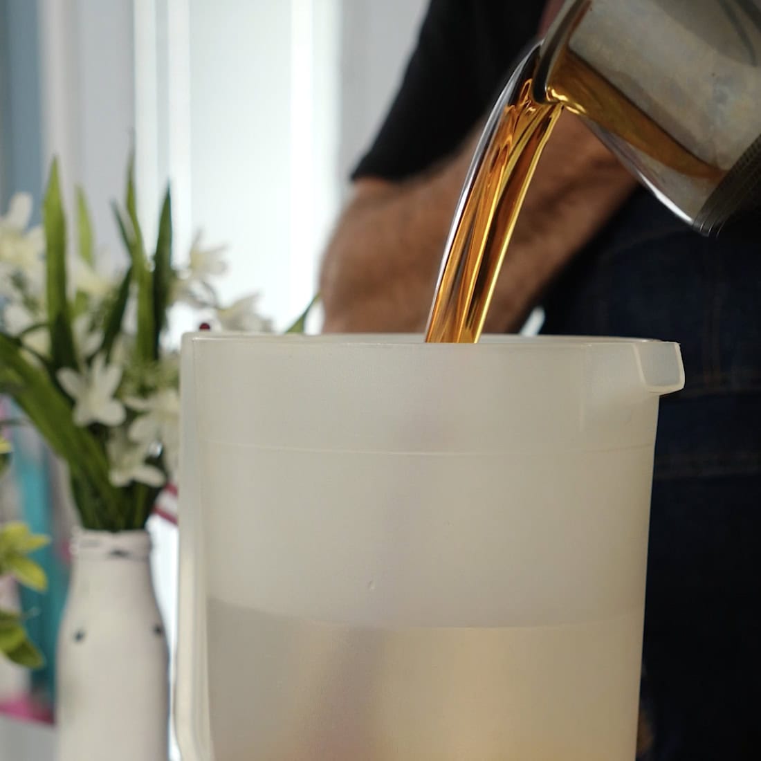 Tim pouring tea water into the pitcher