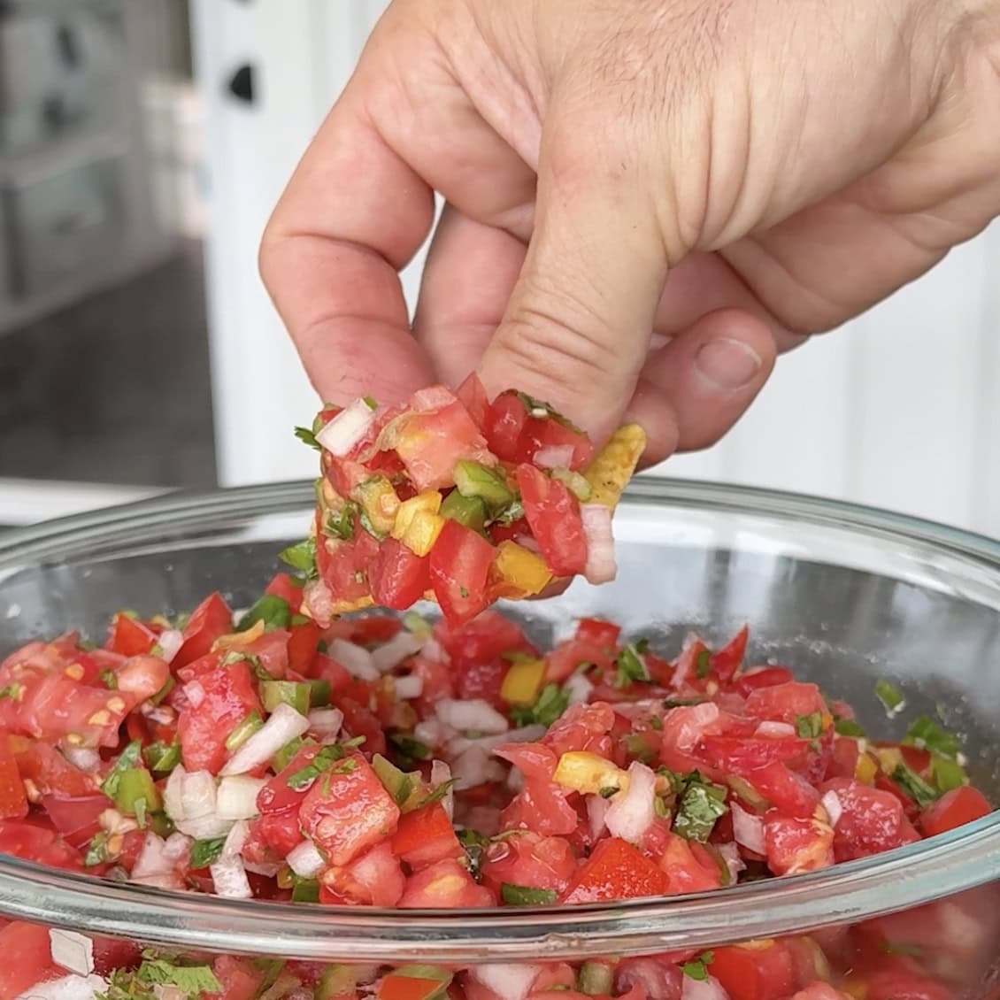 A chip scooping up salsa.