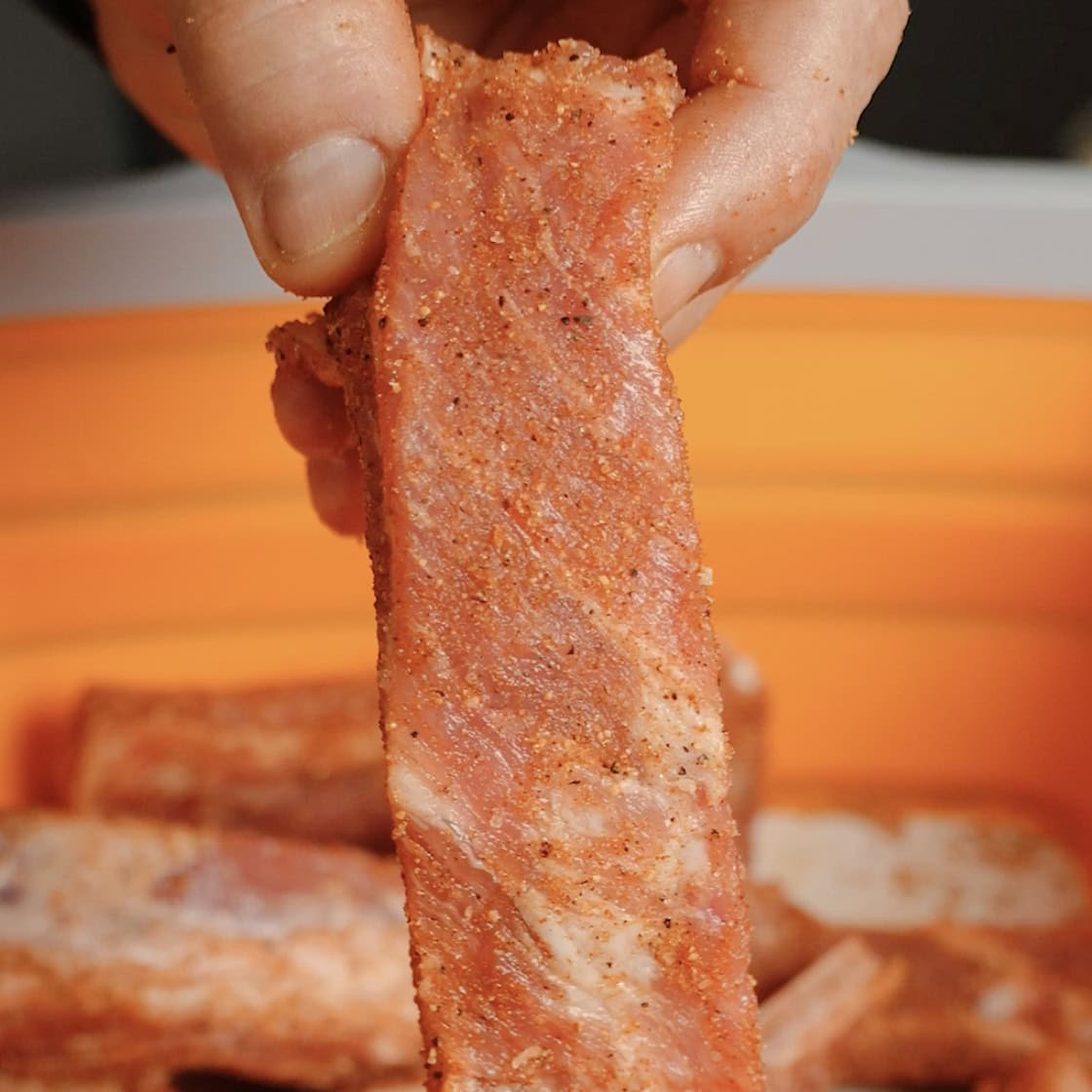 A rib with seasoning on it.