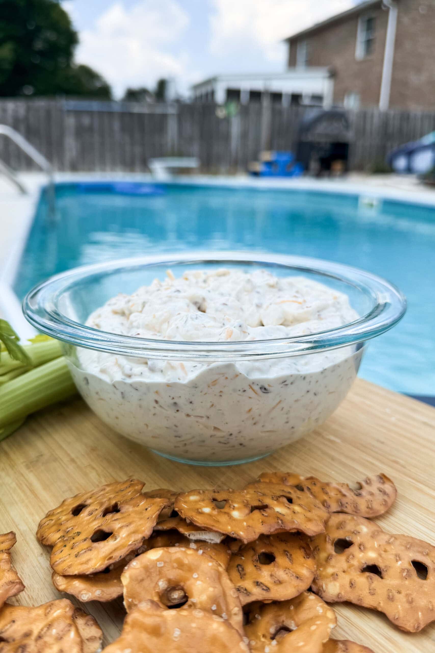 A dip with pretzels and celery.