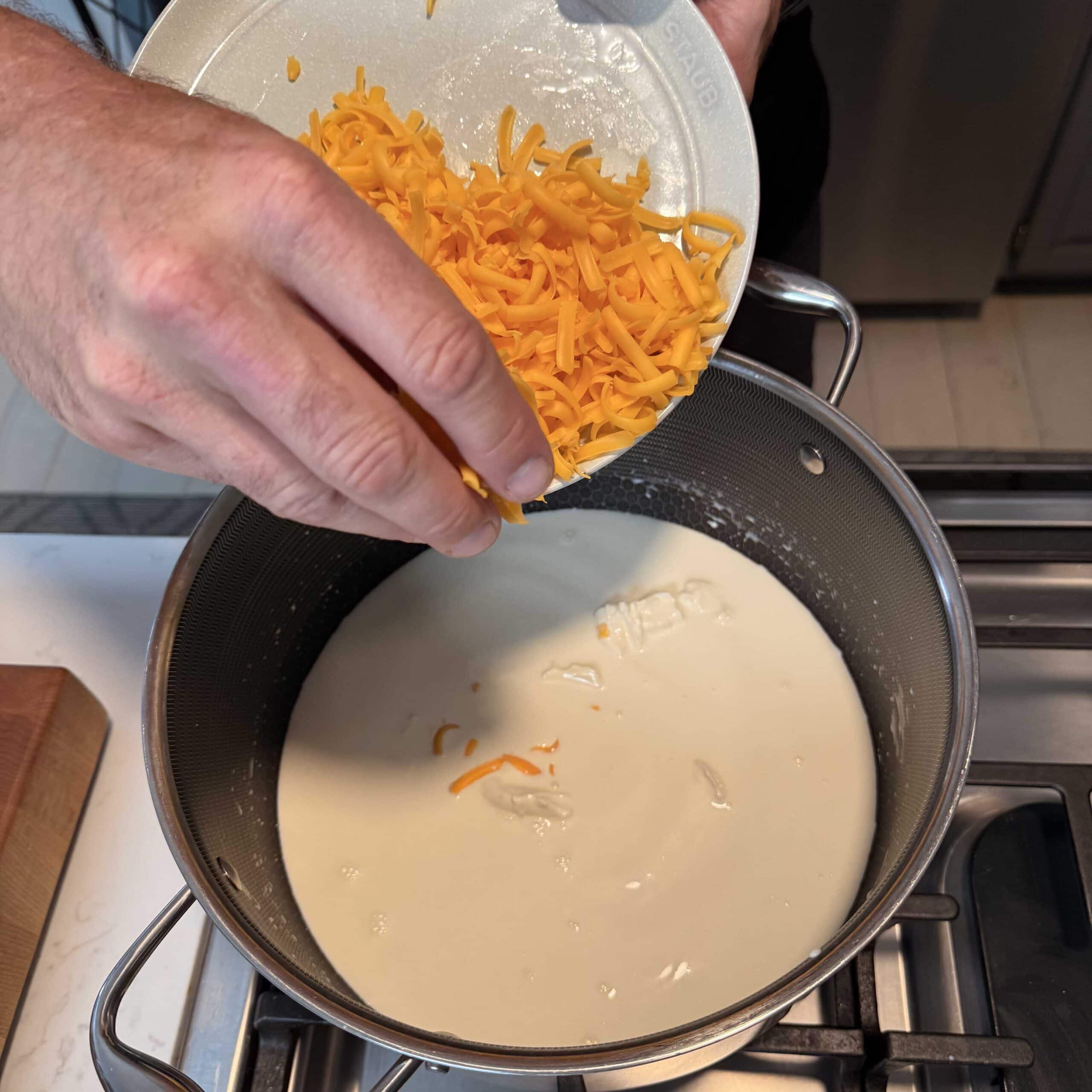 Cheese going into a stock pot.
