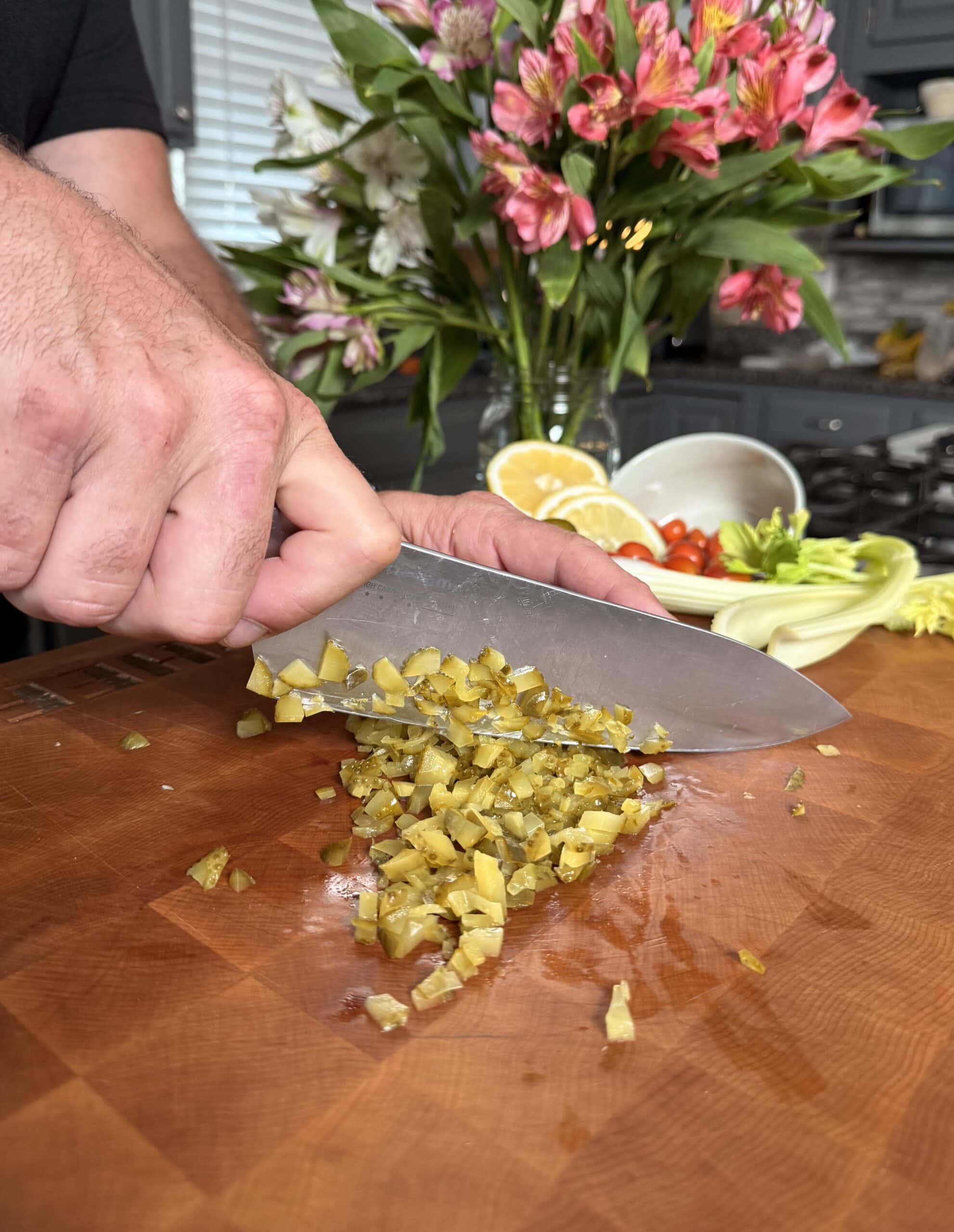 Diced pickles on a cutting board.