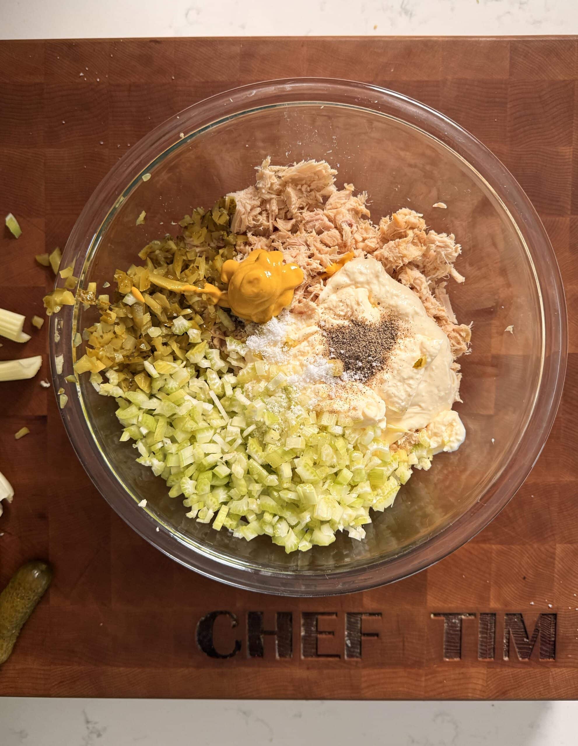 Chicken Salad on a plate with celery, crackers and lemon.