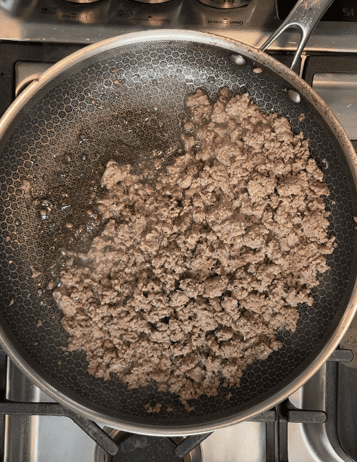 Beef browning in a skillet.