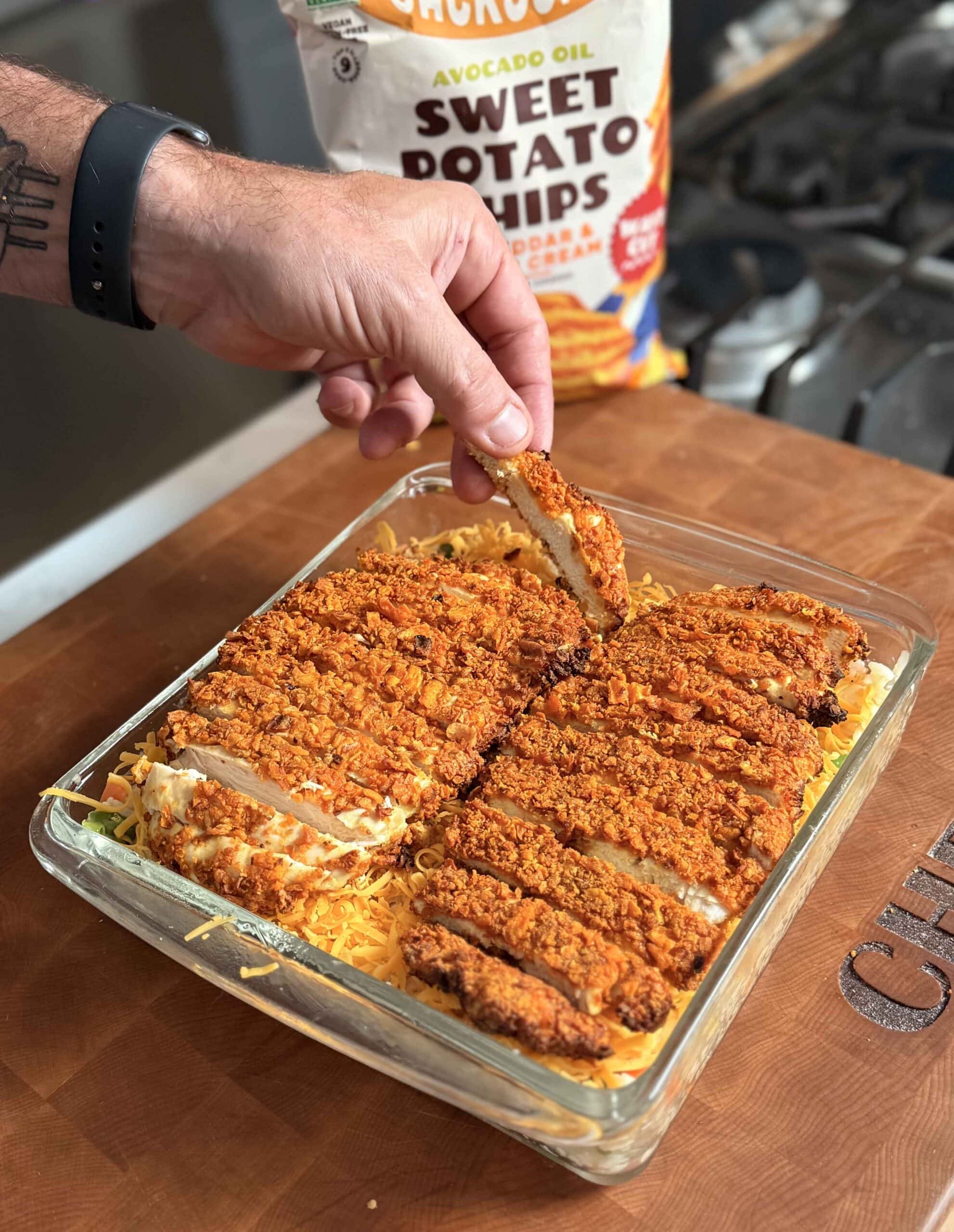 Breaded chicken breasts on a rice in a baking dish.