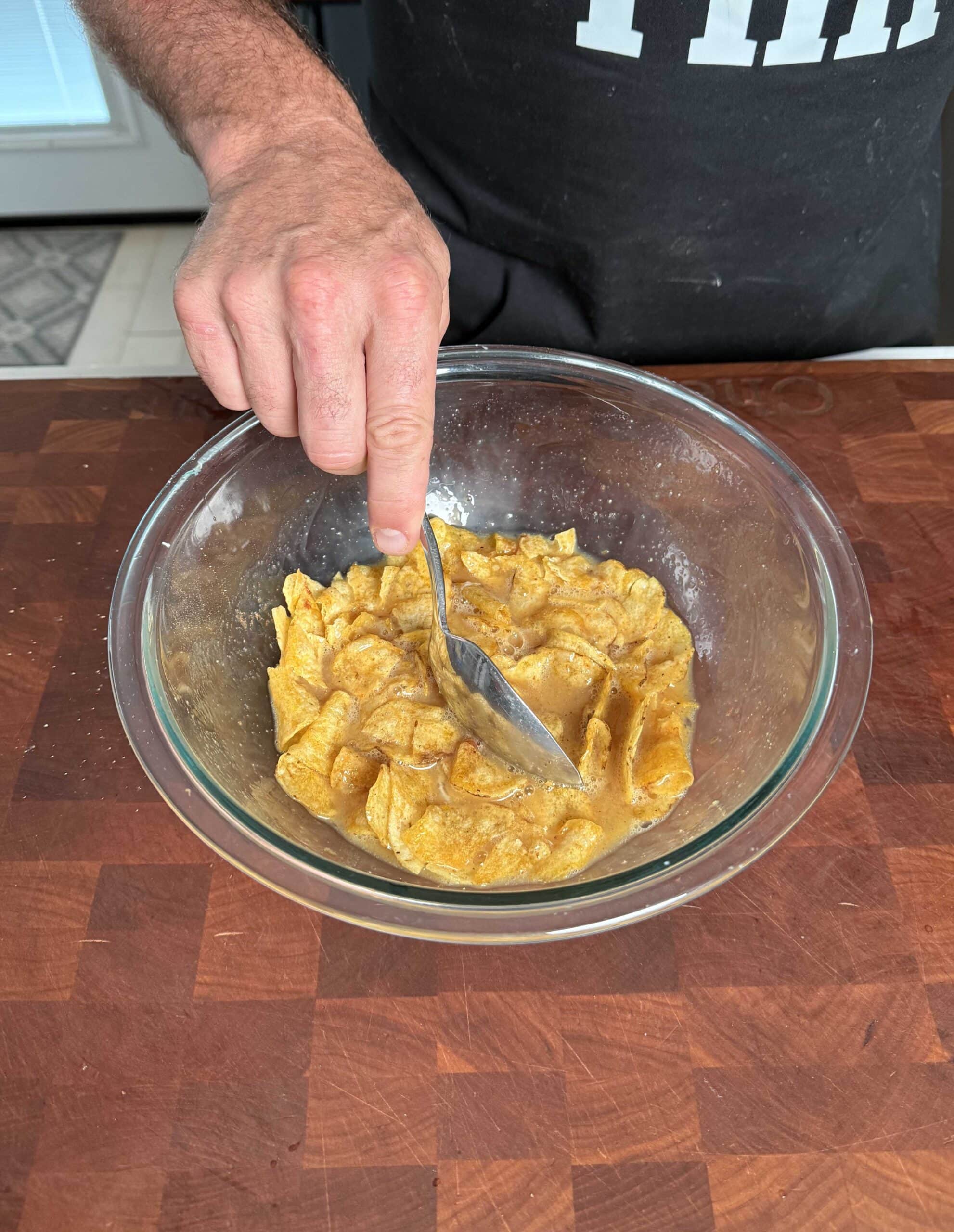 Chips in scrambled eggs in a bowl.