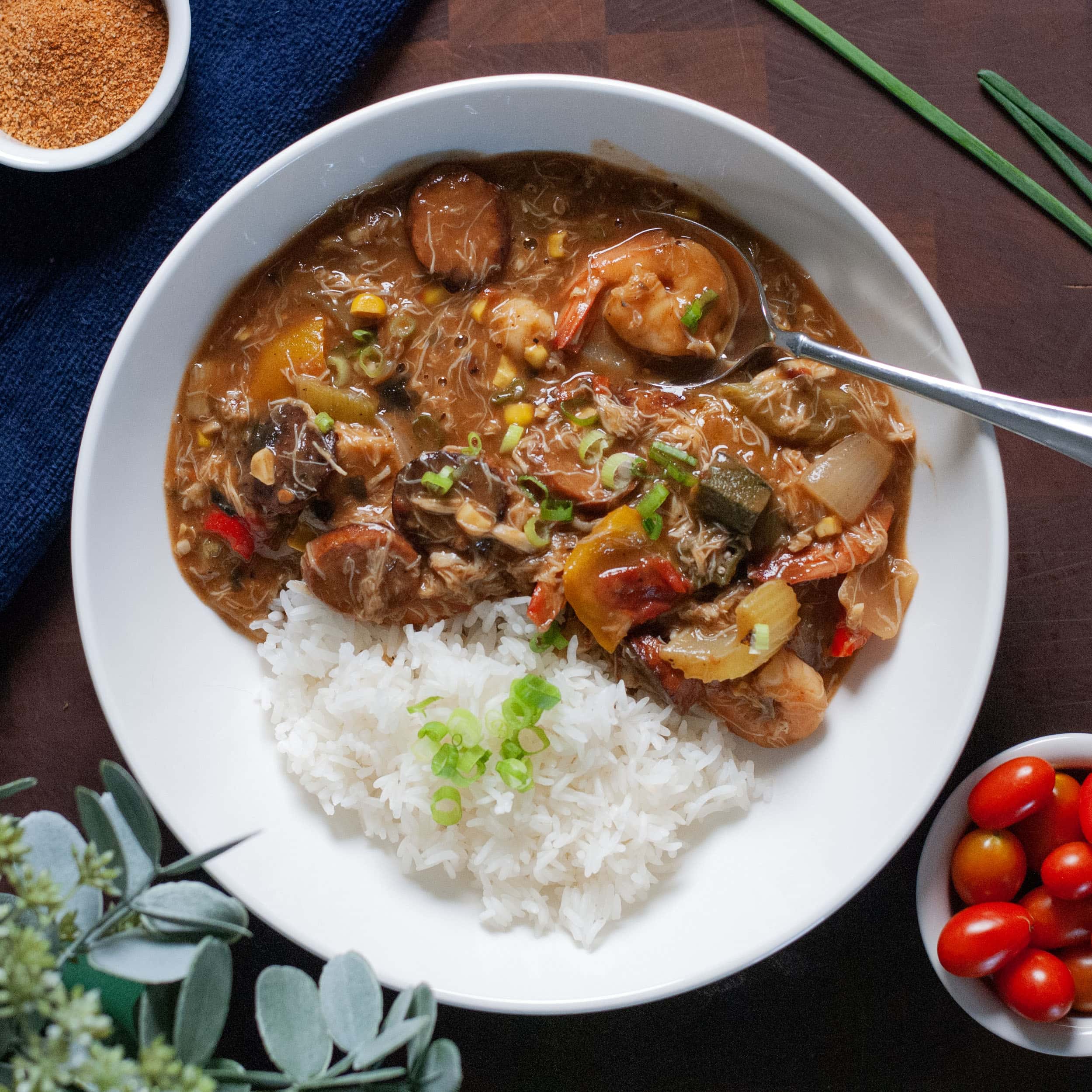 A bowl of gumbo with shrimp and rice.