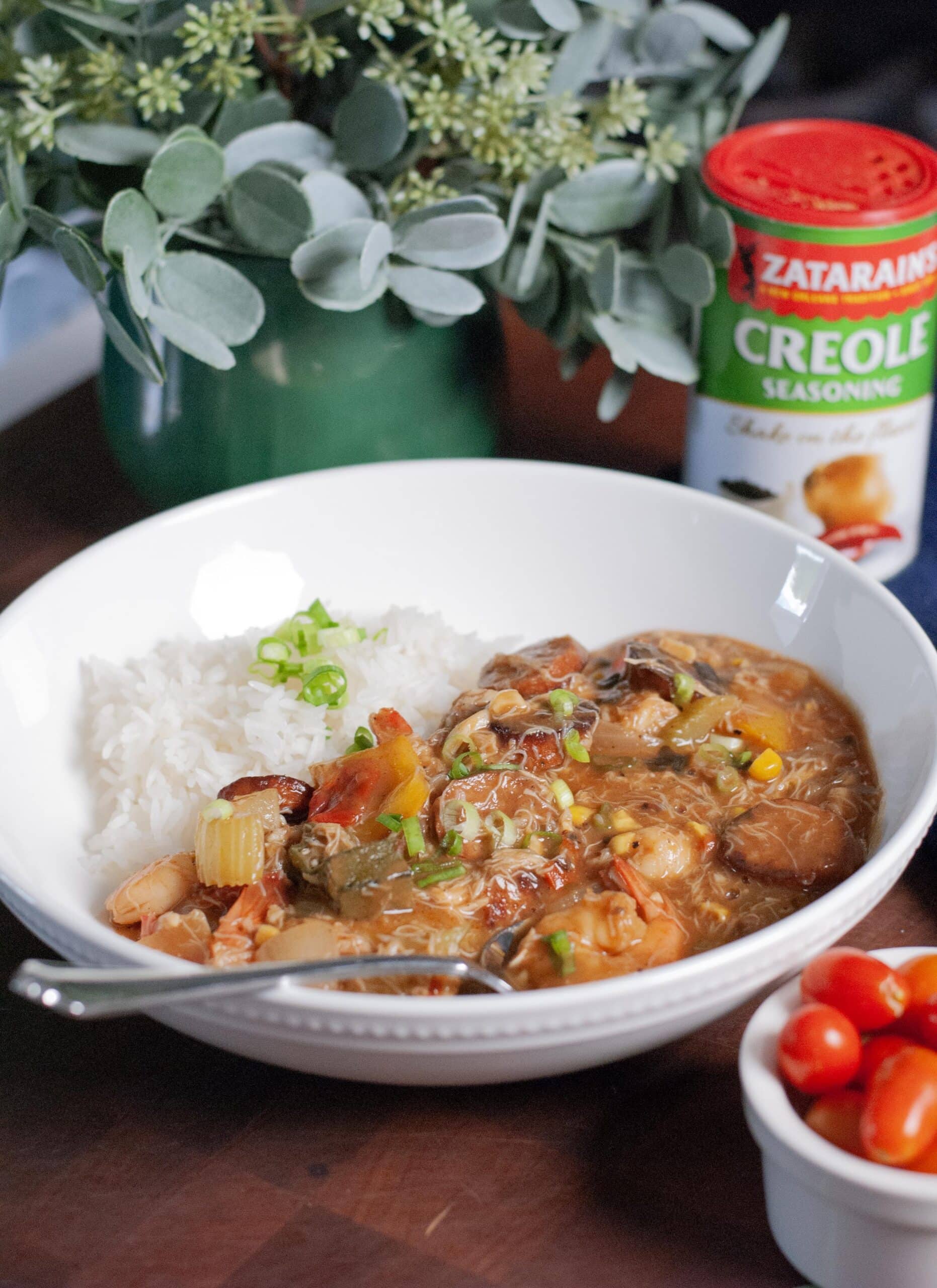 A bowl of gumbo with shrimp and rice.