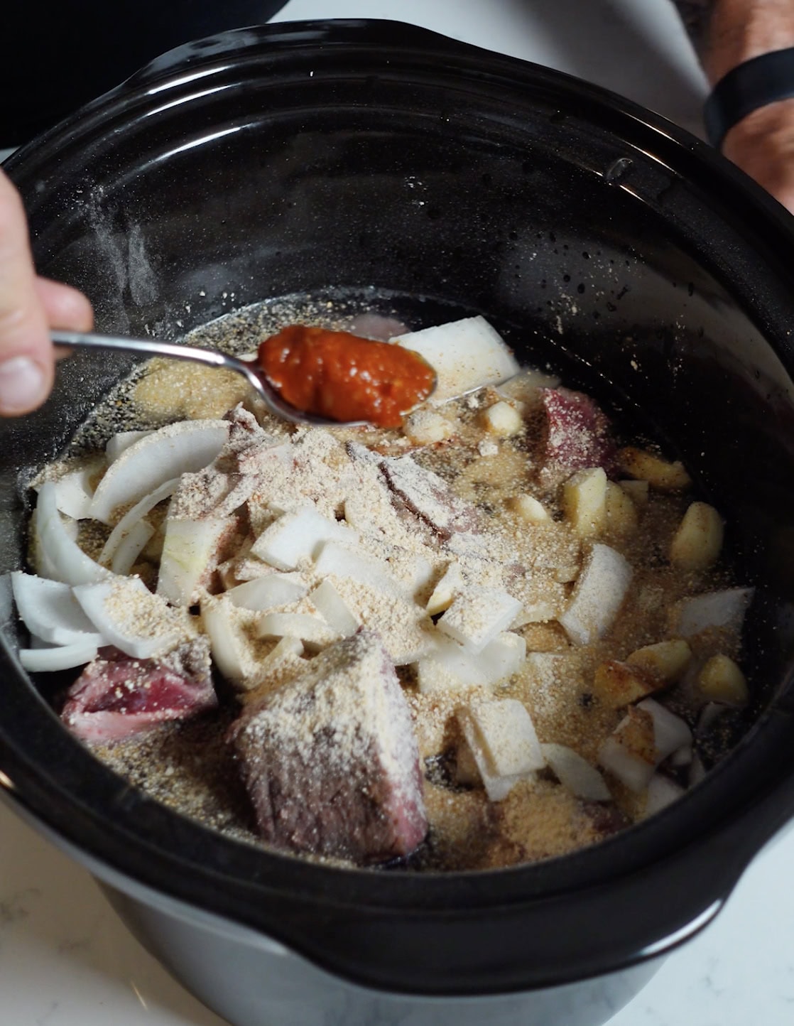 Roast, onions and ingredients in a slow cooker.