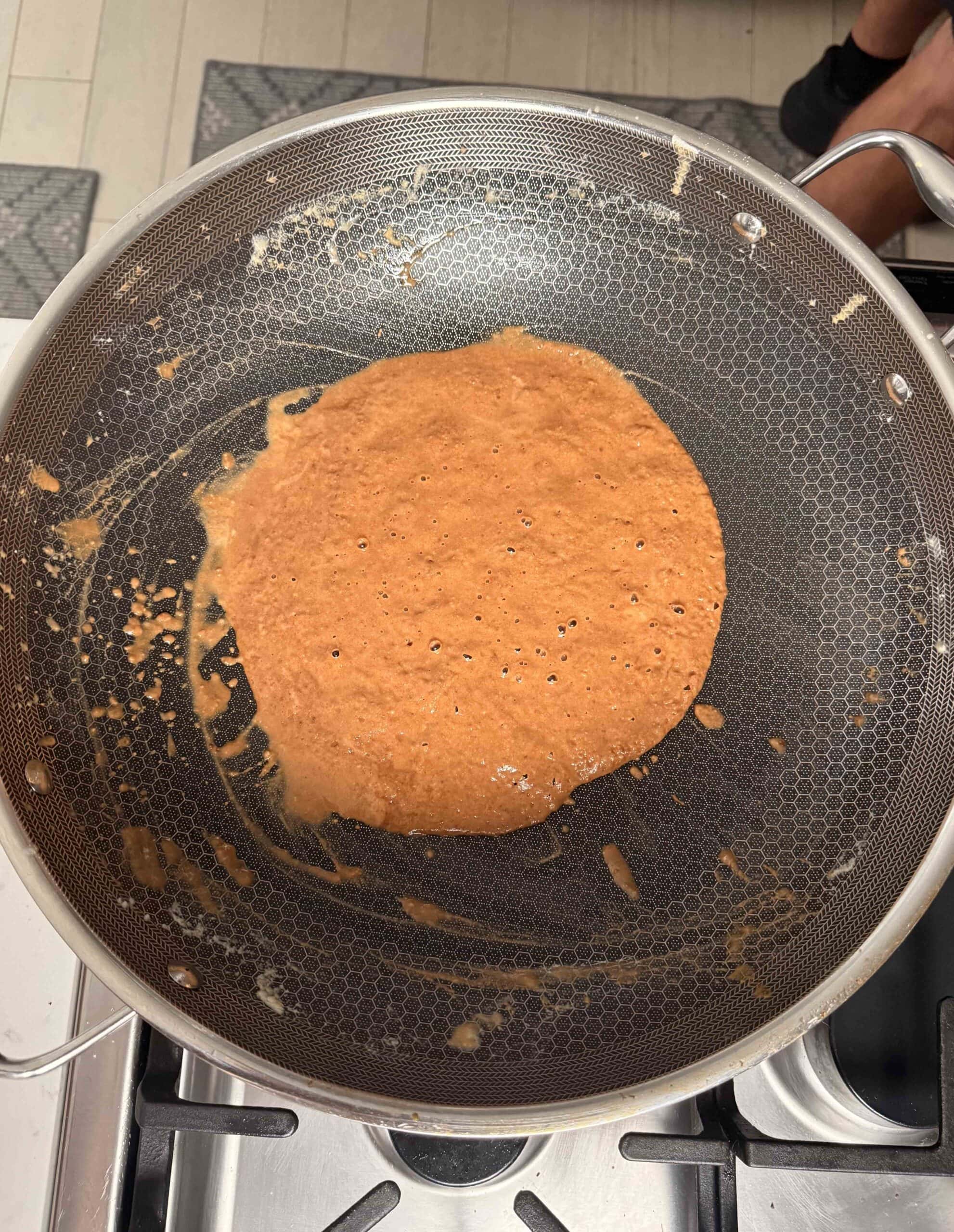 A chocolate brown roux in a pan.