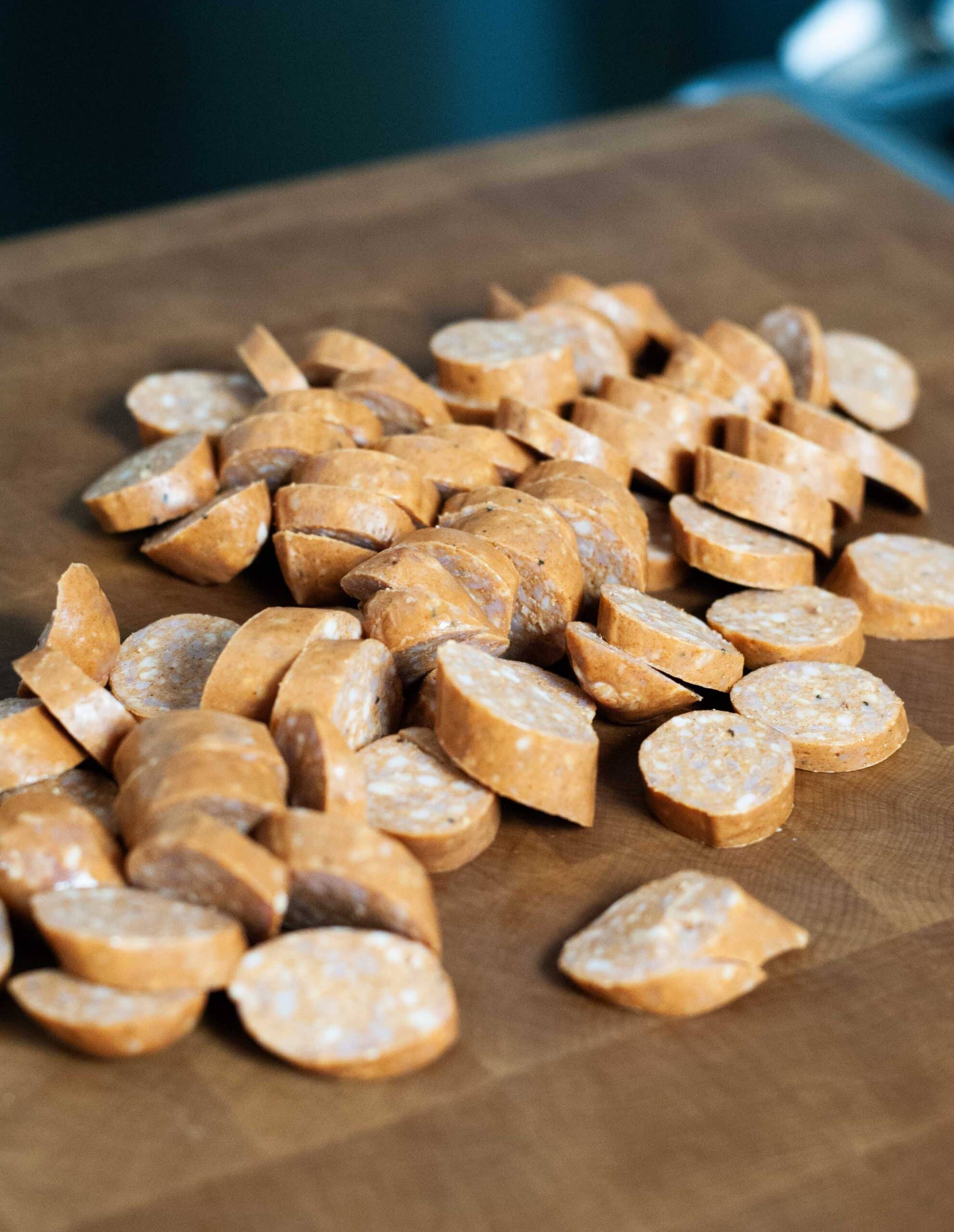 Sausage sliced on a bias on a board.