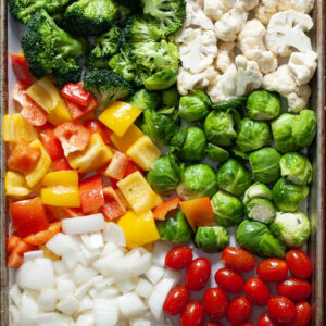 Seasoned vegetables on a sheet pan.