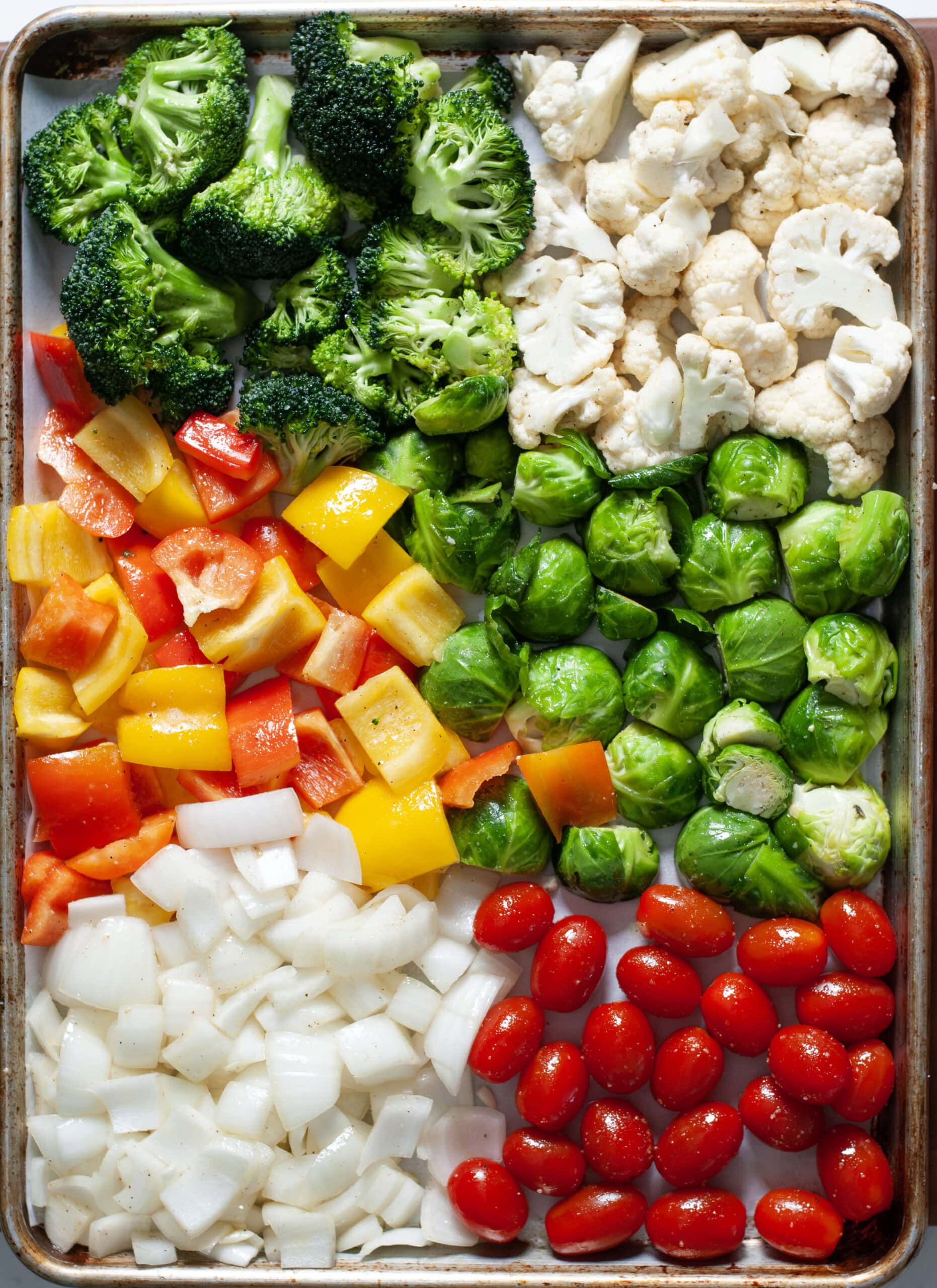 Seasoned vegetables on a sheet pan.