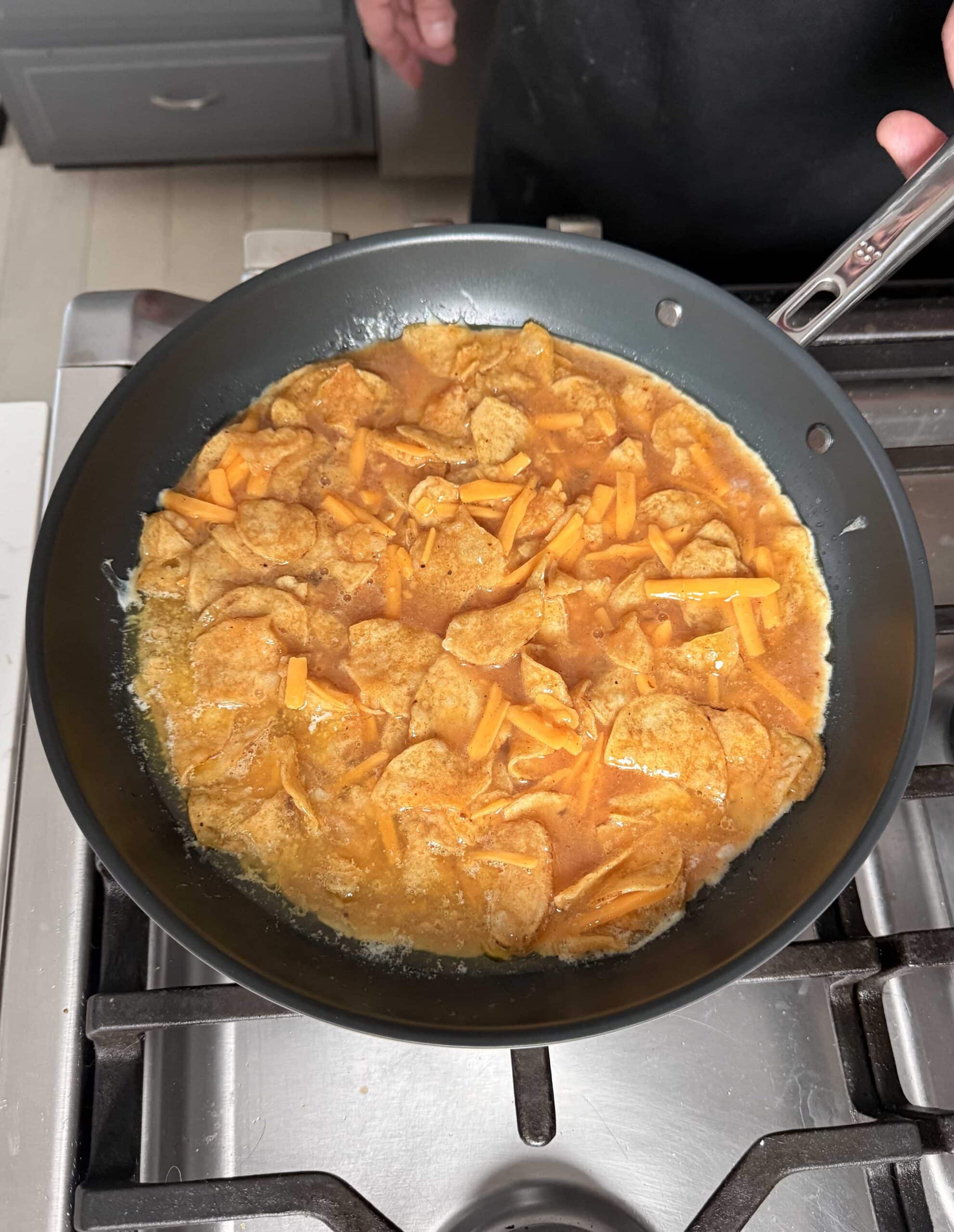 Eggs and chips in a skillet.