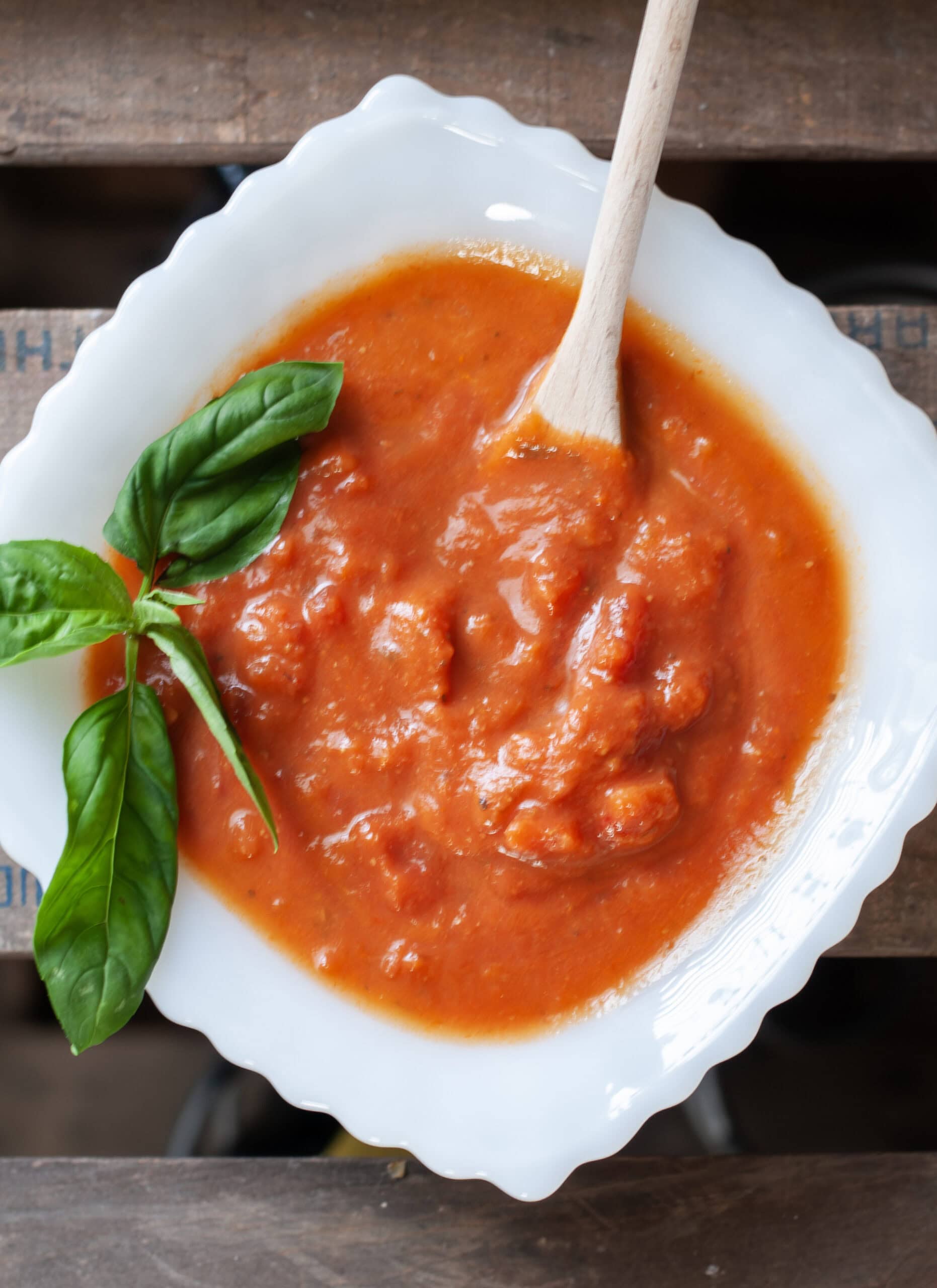 Tomato sauce in a bowl with basil.