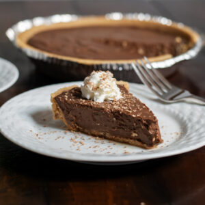 Slice of chocolate pie on a white plate.