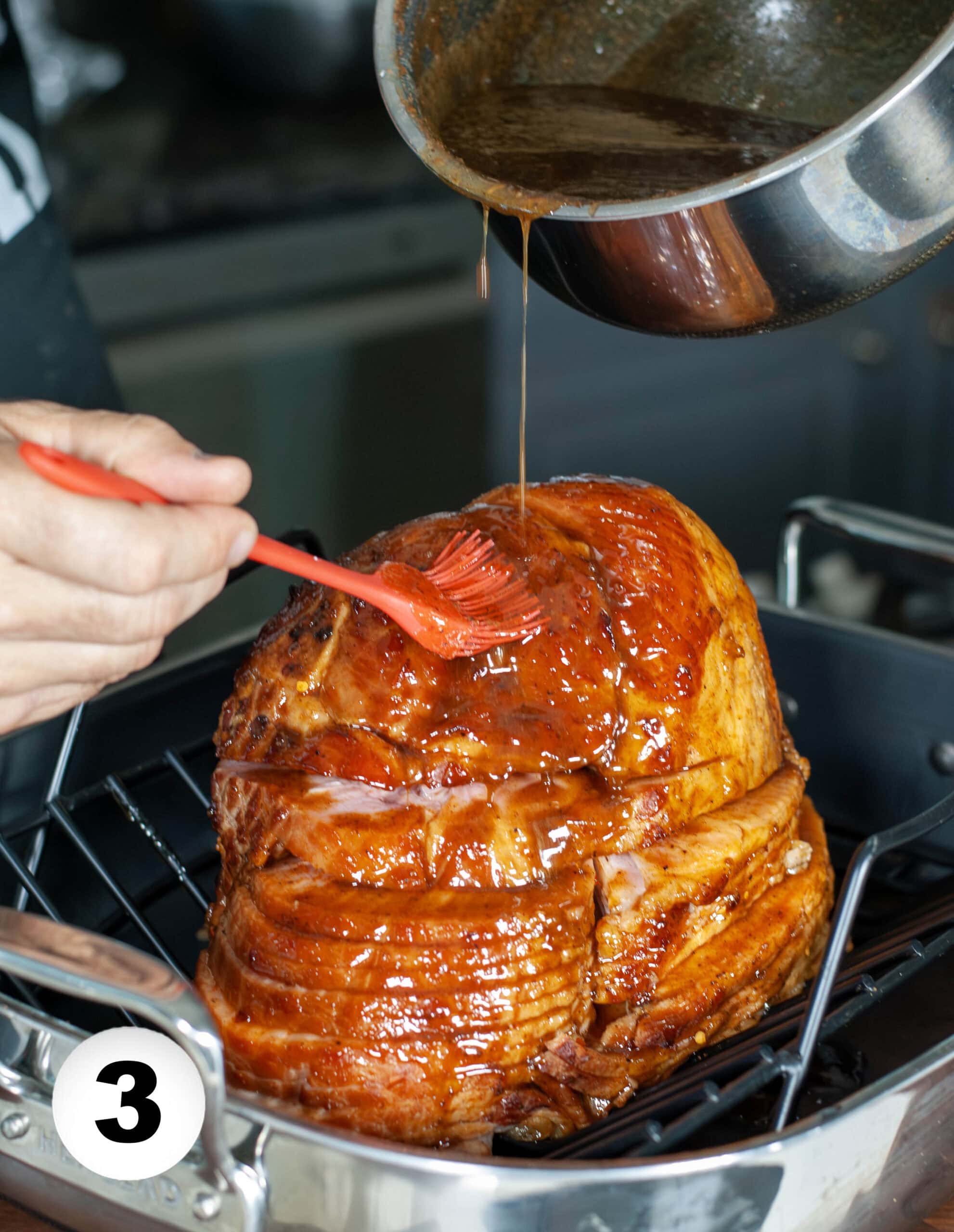 Glazing a ham with a basting brush.