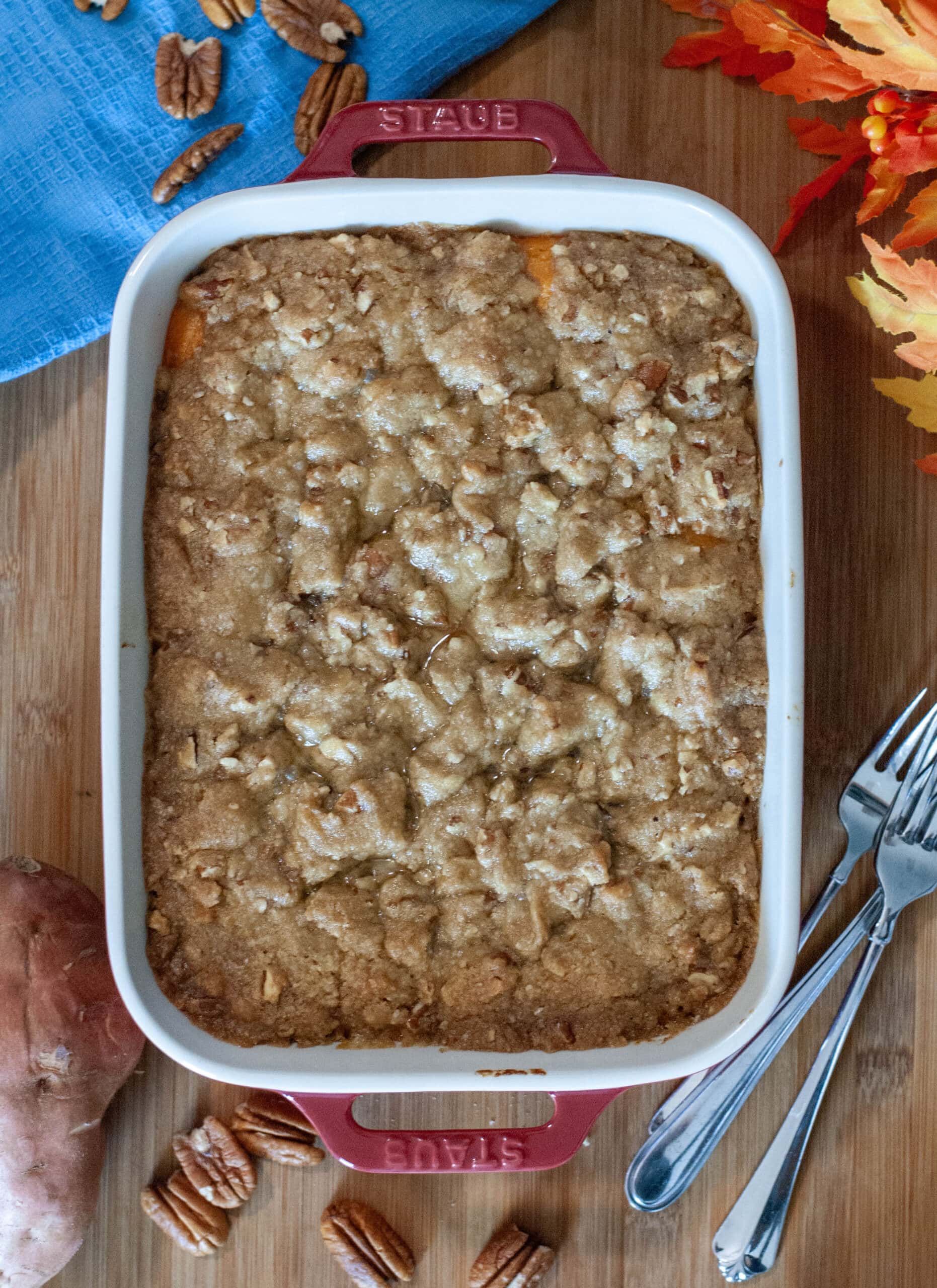 Sweet potato casserole in white baking dish with pecans.