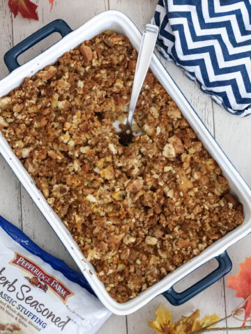 Pepperidge Farm stuffing in a blue baking dish next to fall leaves.