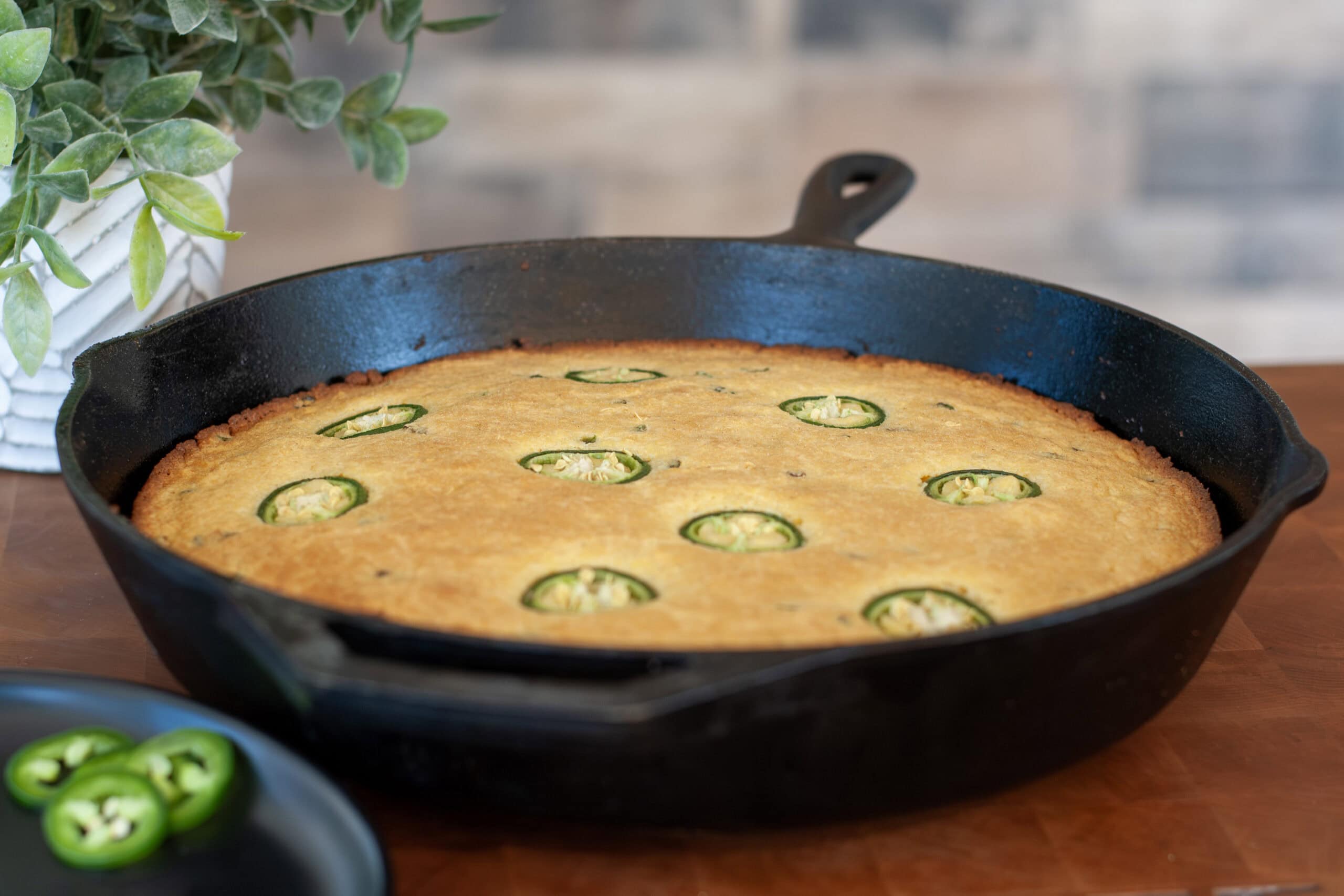 Smoked jalapeño cornbread in a cast iron skillet.