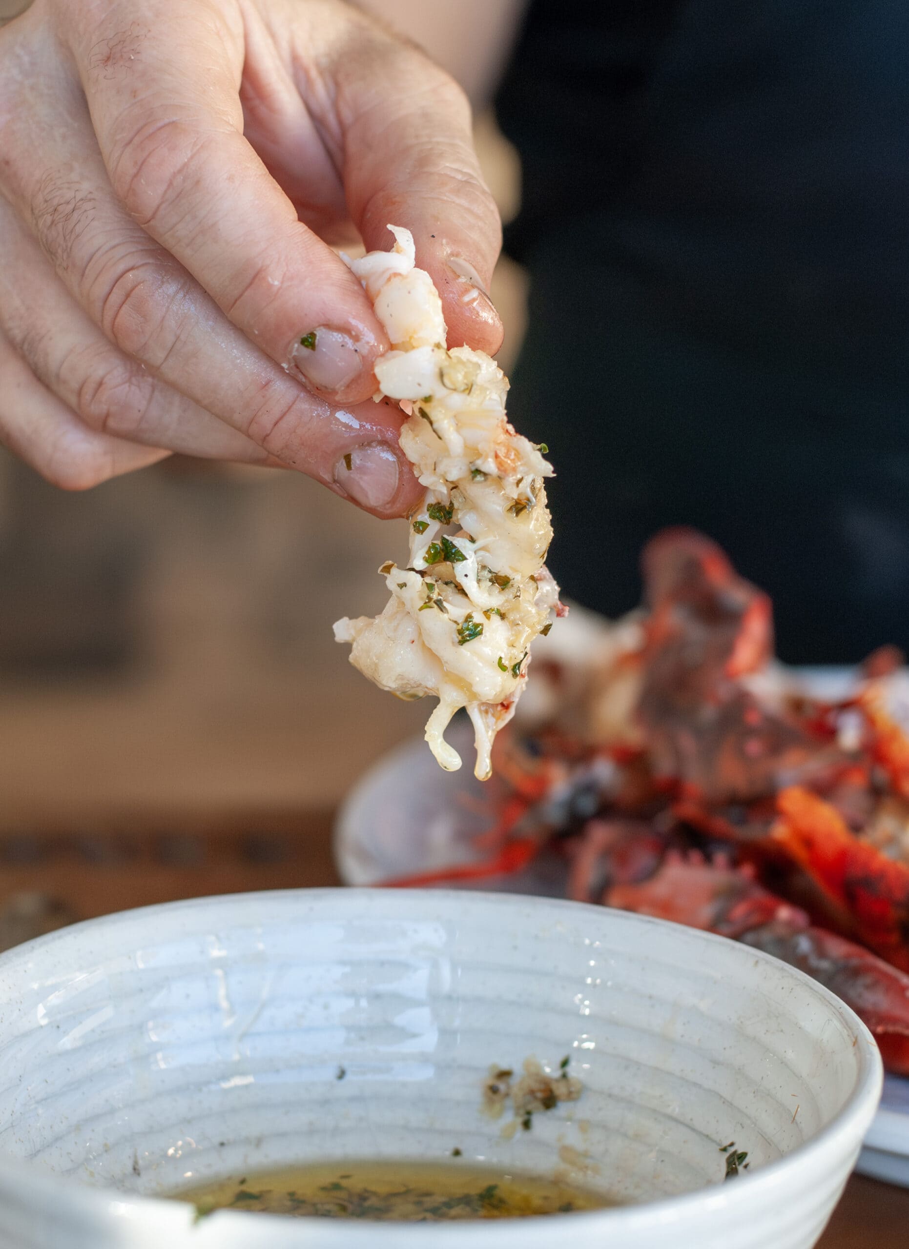 A piece of lobster coated in lemon garlic butter.