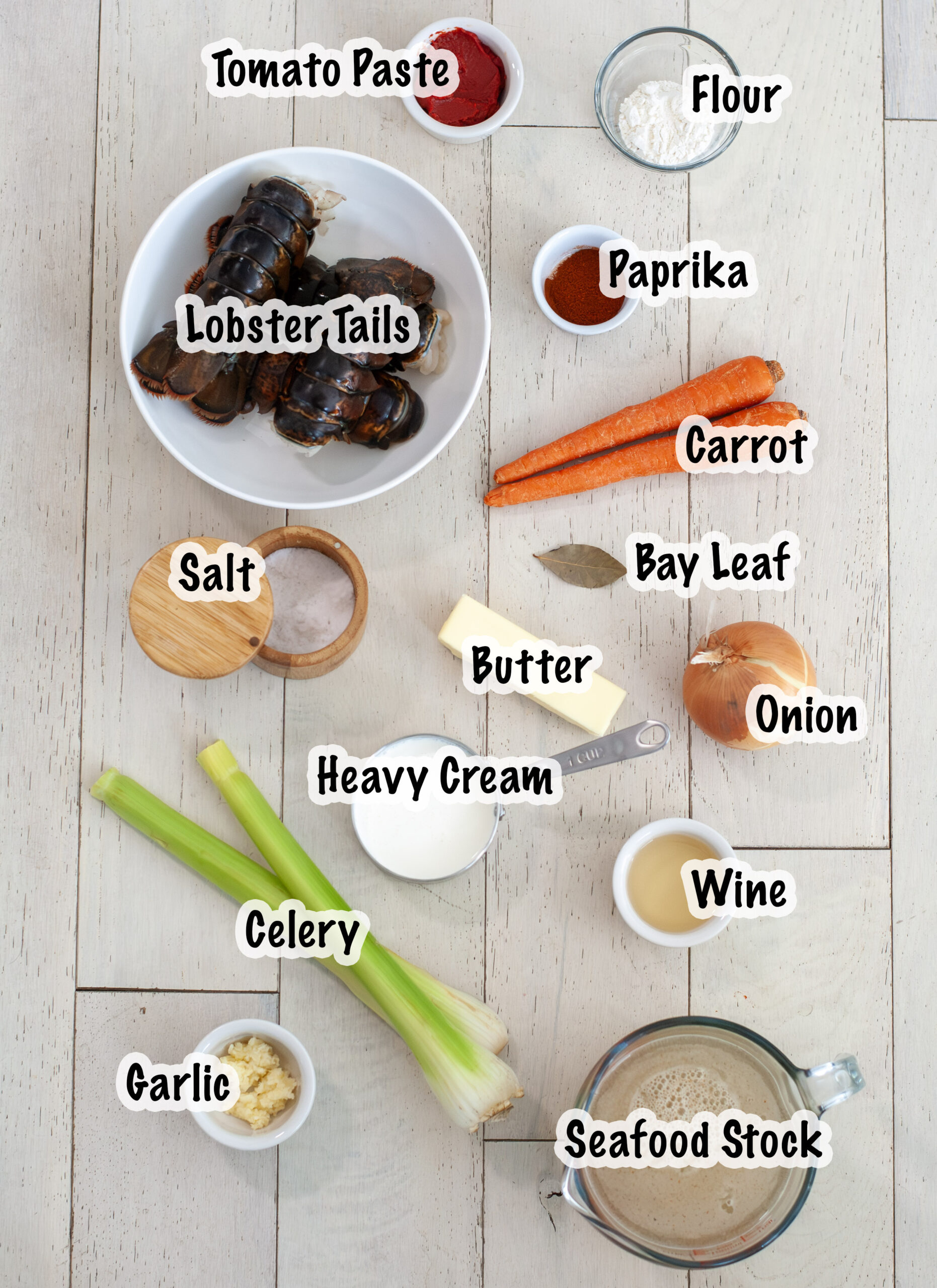 A lobster sauce on ravioli next to garlic cloves.