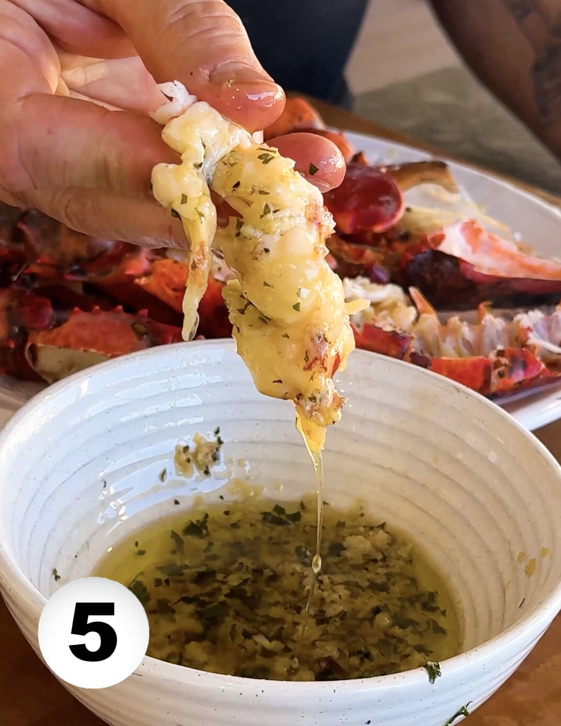 A chunk of lobster coated with garlic butter.