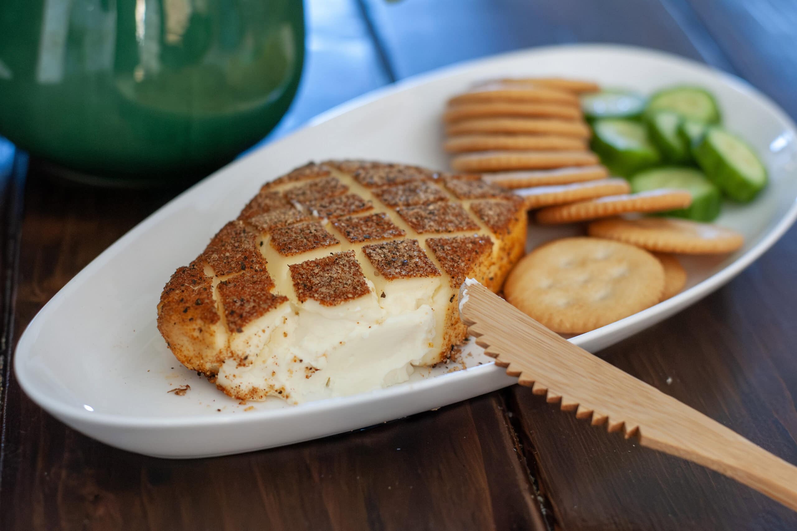 A block of smoked cream cheese with seasoning.