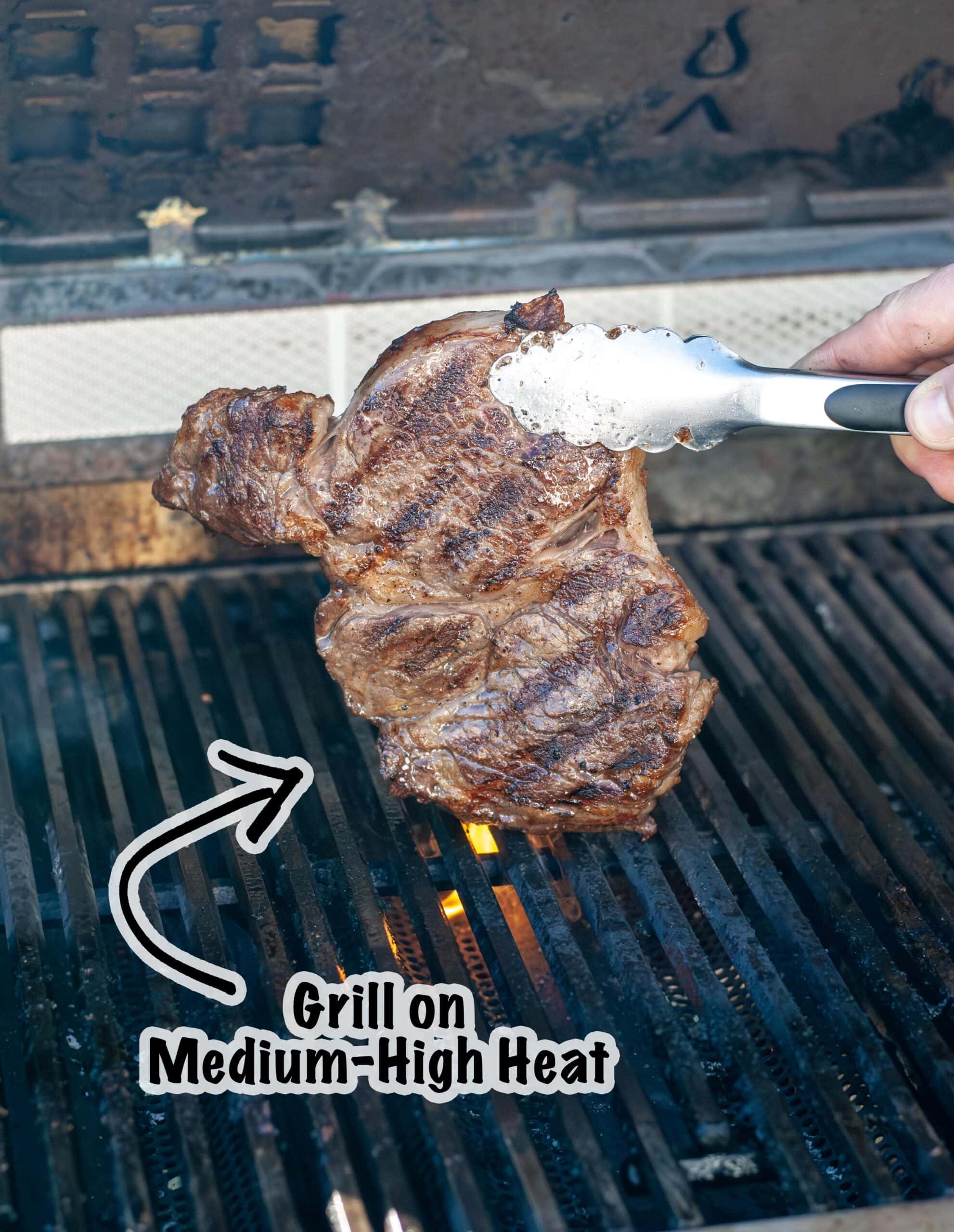 A steak being grilled on a medium high heat.