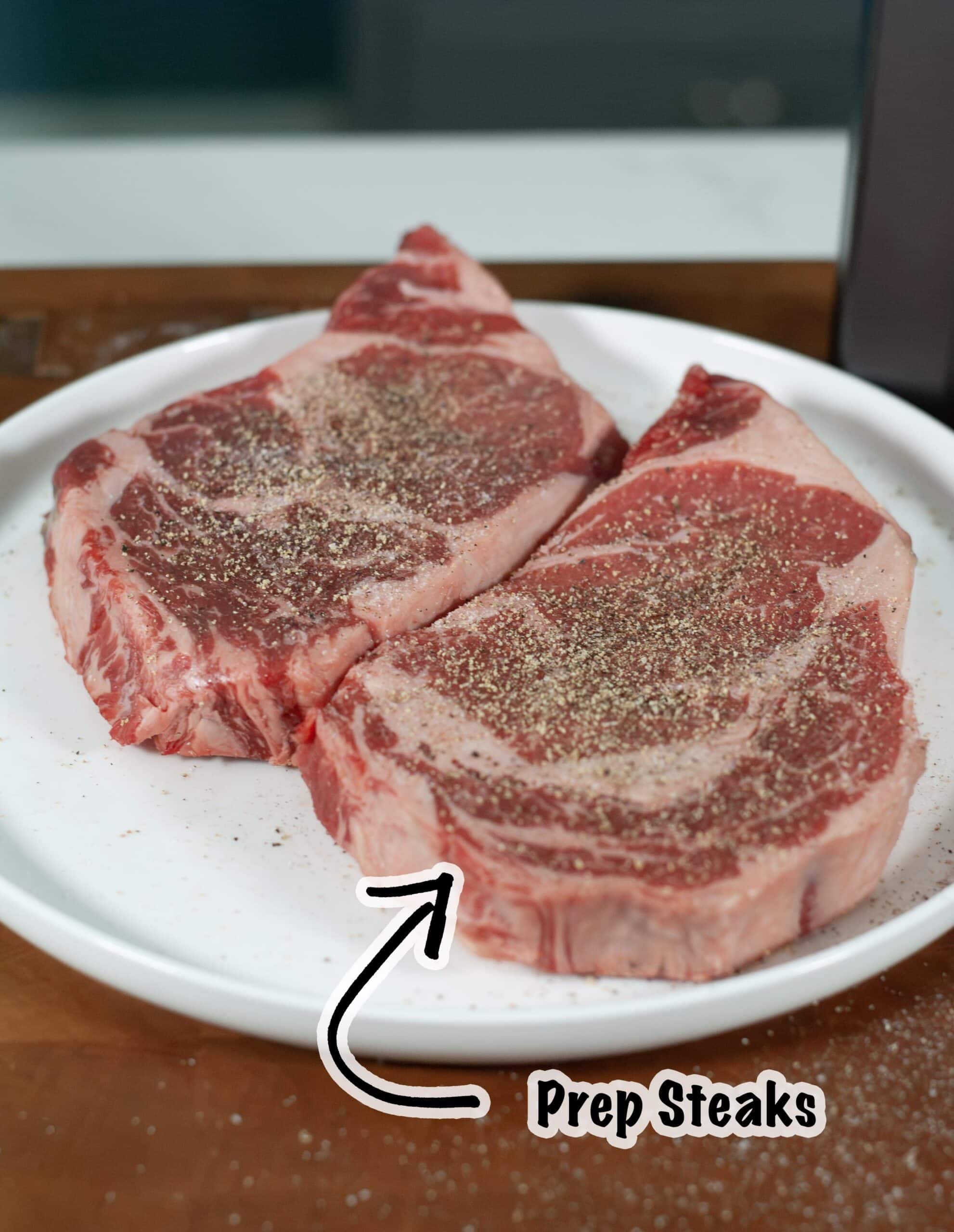 Ribeye steaks seasoned with salt and pepper.